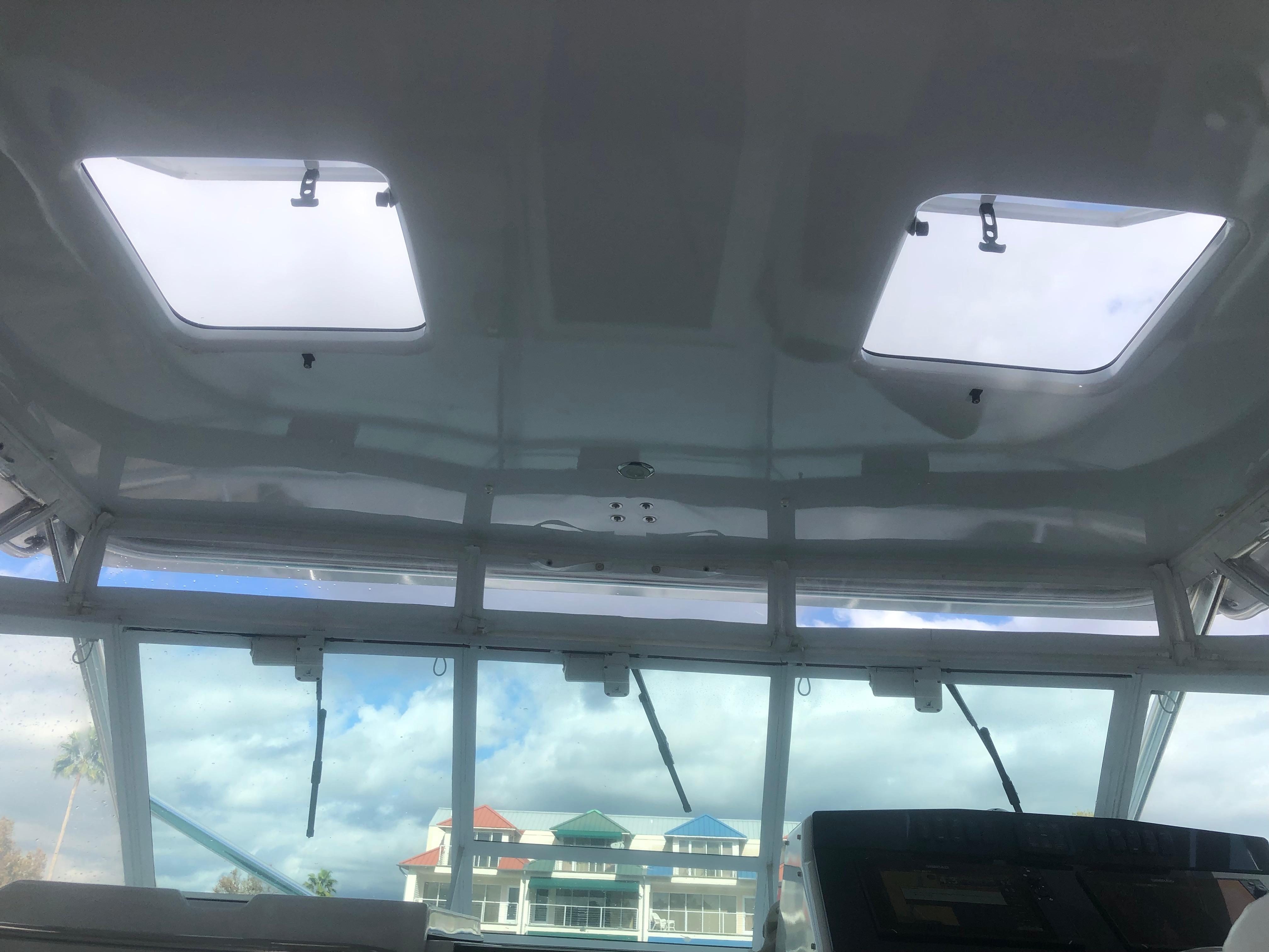 Cabo-35 Express 1995 -AL-US-Interior view of 1995 Cabo 35 Express boat with skylights and marina backdrop.-9547451 | Thumbnail