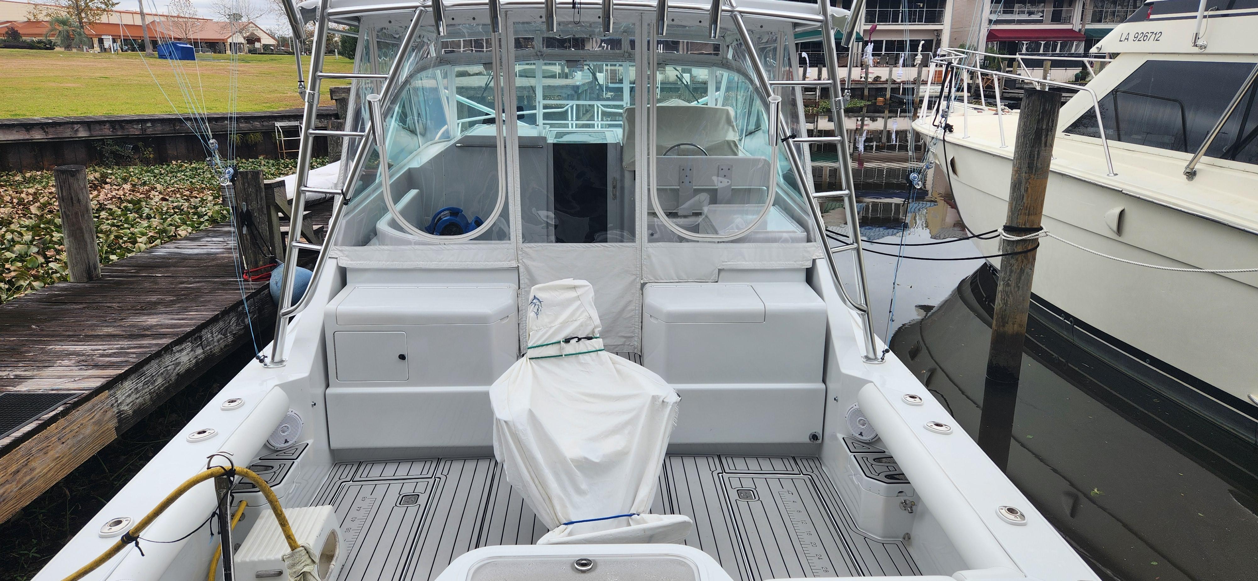 Cabo-35 Express 1995 -AL-US-1995 Cabo 35 Express boat docked, featuring spacious deck and covered seating area.-9547451 | Thumbnail