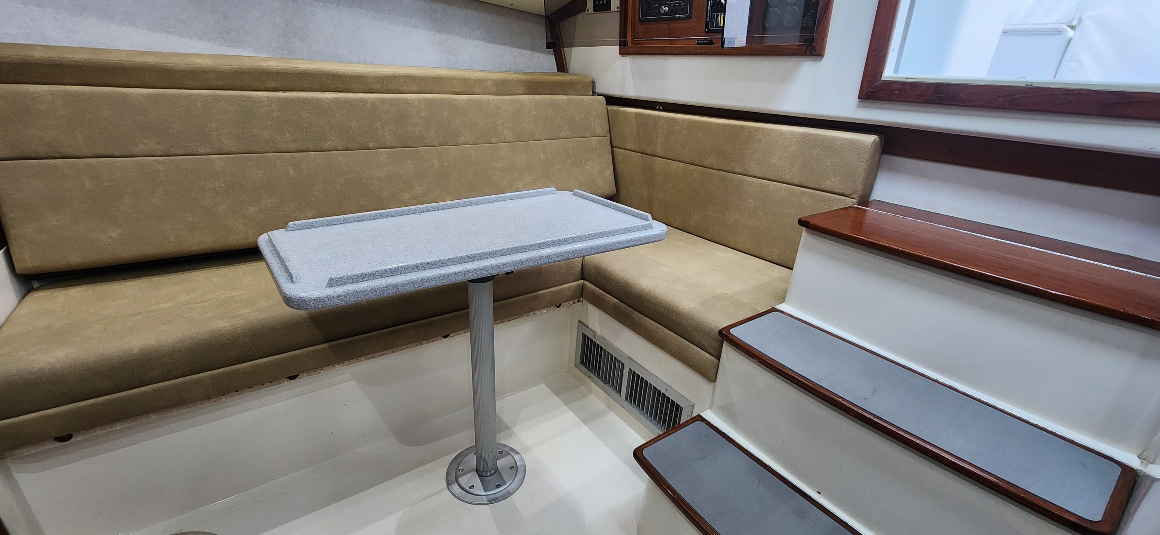 Cabo-35 Express 1995 -AL-US-1995 Cabo 35 Express interior with beige seating, table, and stairs.-9547451 | Thumbnail