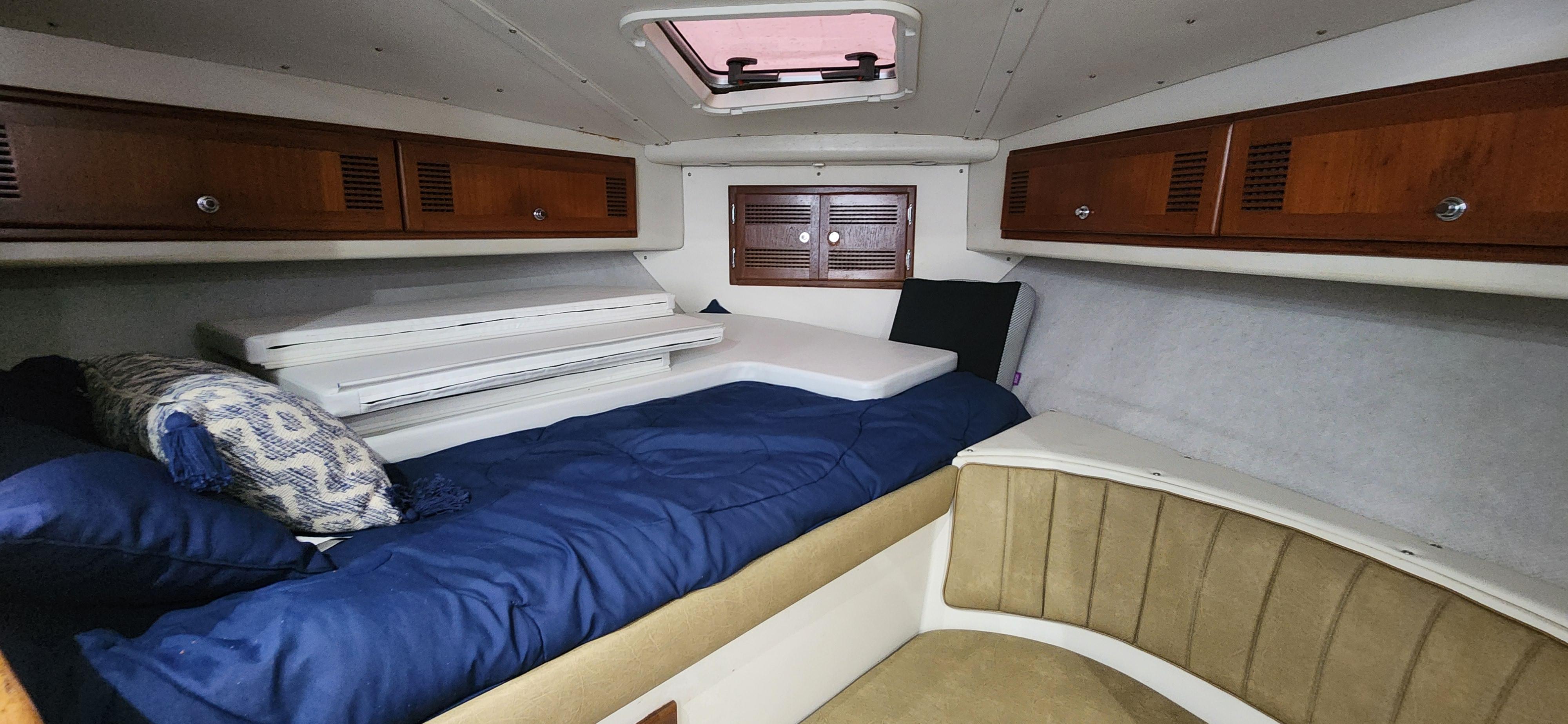 Cabo-35 Express 1995 -AL-US-Interior cabin of a 1995 Cabo 35 Express boat with cozy bedding and wooden cabinets.-9547451 | Thumbnail