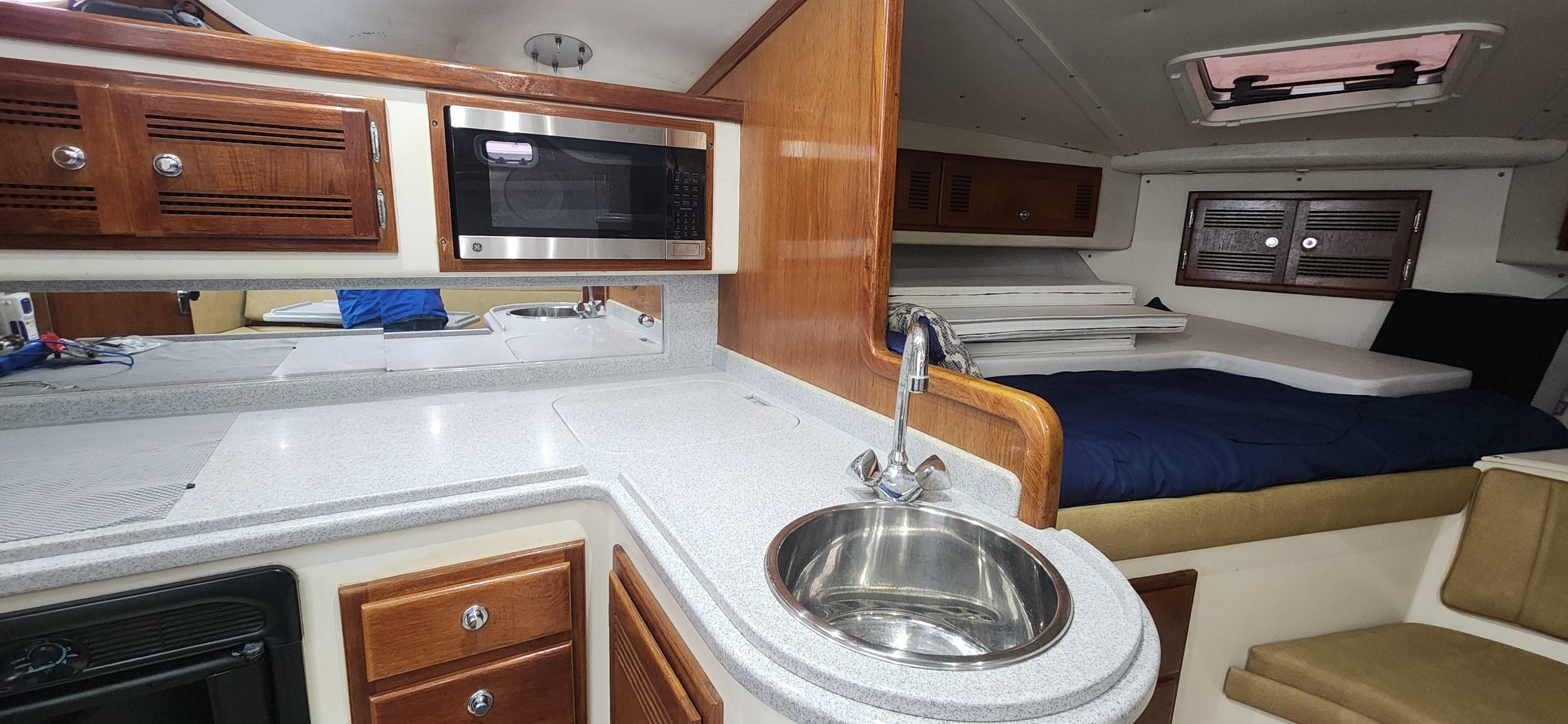 Cabo-35 Express 1995 -AL-US-Interior of 1995 Cabo 35 Express boat with kitchenette and sleeping area.-9547451 | Thumbnail