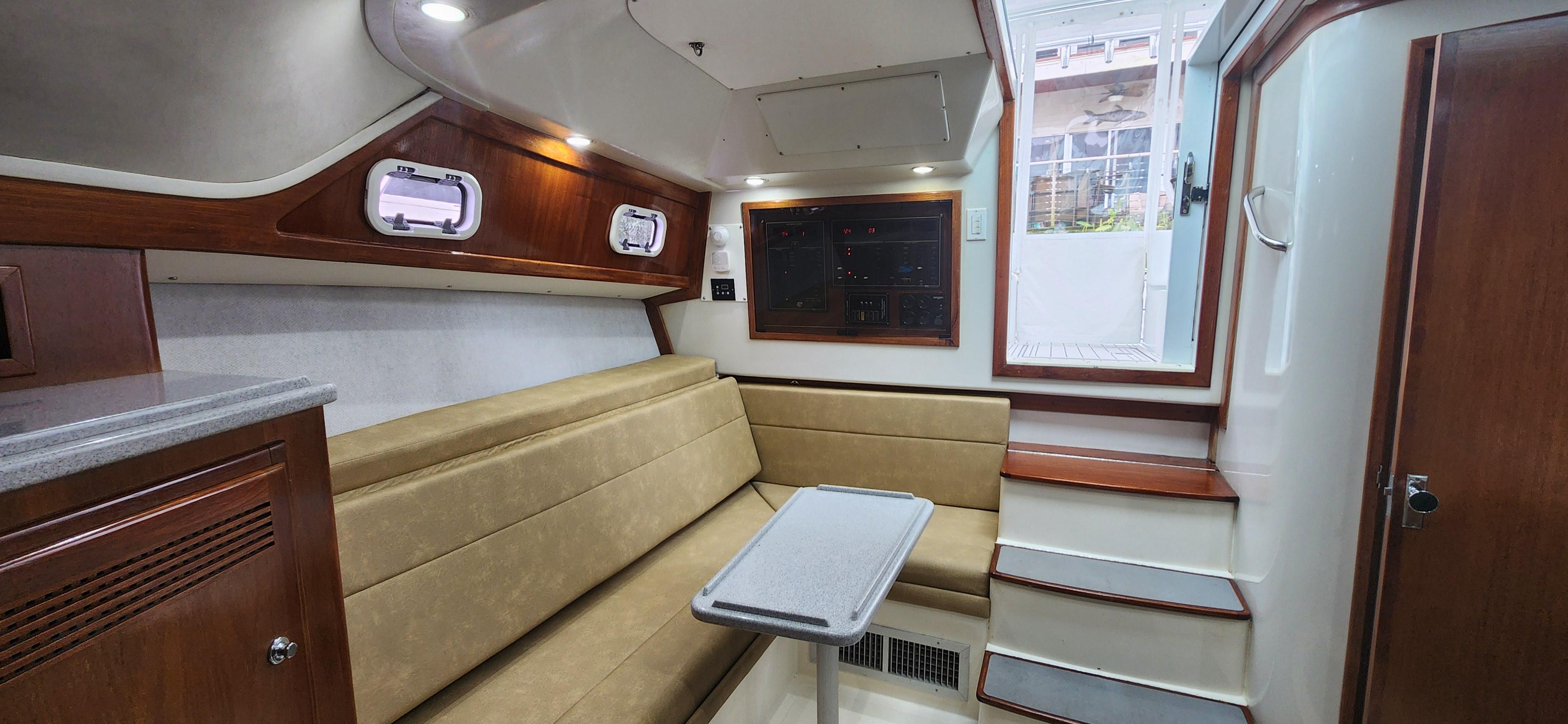 Cabo-35 Express 1995 -AL-US-1995 Cabo 35 Express cabin interior with beige seating and wooden accents.-9547451 | Thumbnail