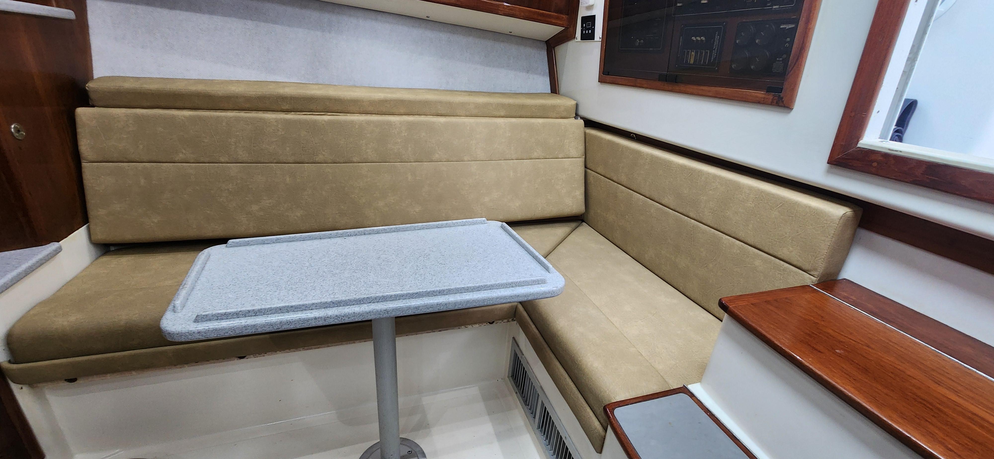 Cabo-35 Express 1995 -AL-US-1995 Cabo 35 Express interior with beige seating and a small table.-9547451 | Thumbnail