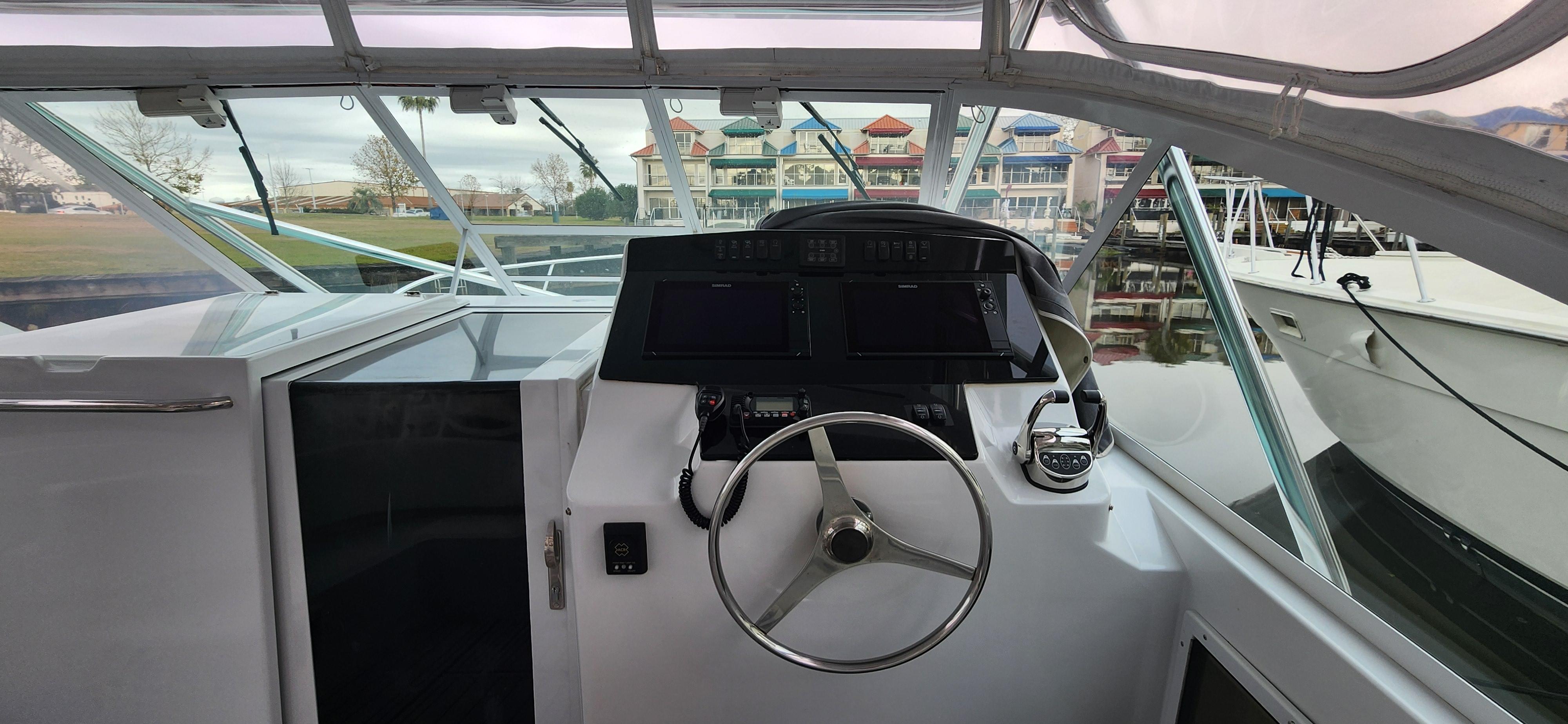 Cabo-35 Express 1995 -AL-US-1995 Cabo 35 Express boat helm with steering wheel and navigation equipment.-9547451 | Thumbnail