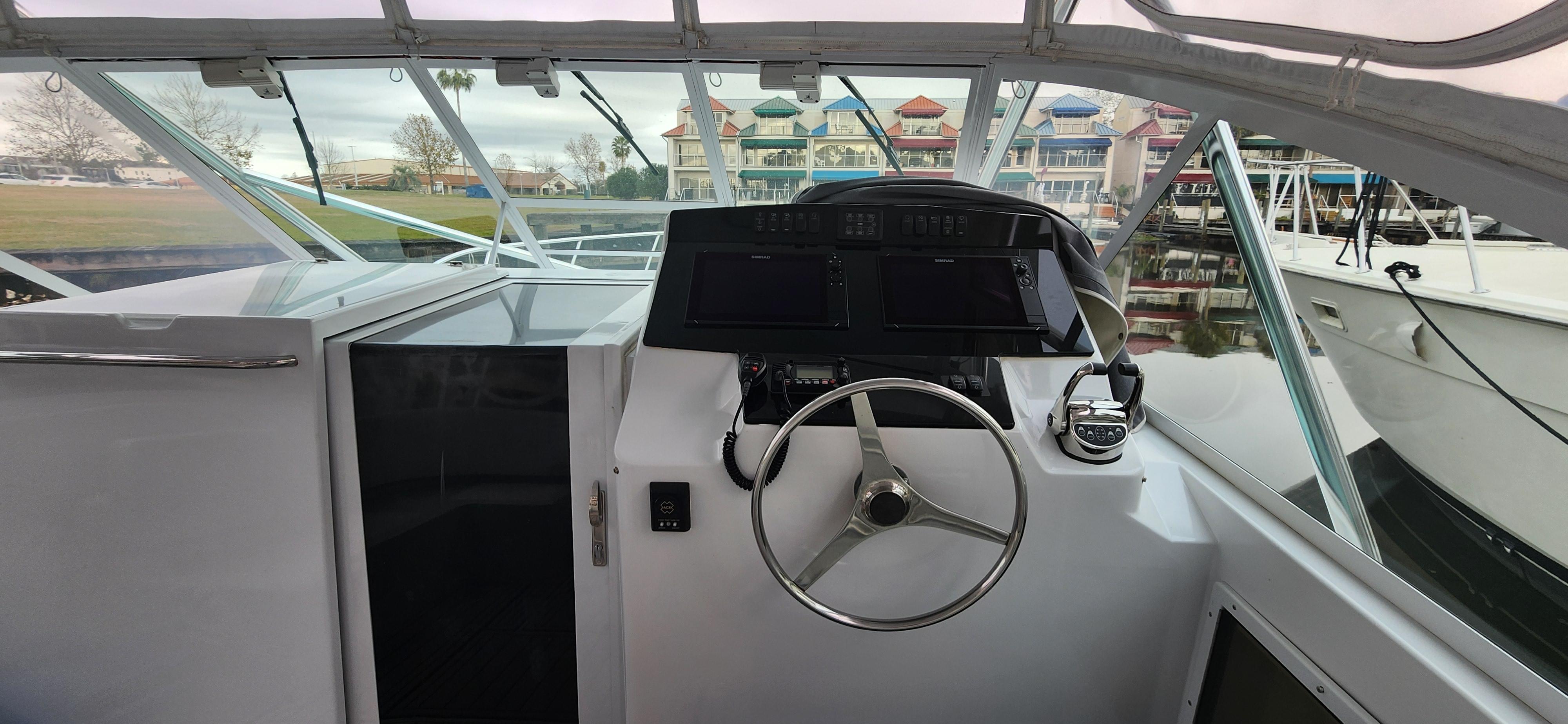 Cabo-35 Express 1995 -AL-US-1995 Cabo 35 Express boat helm with steering wheel and navigation equipment.-9547451 | Thumbnail