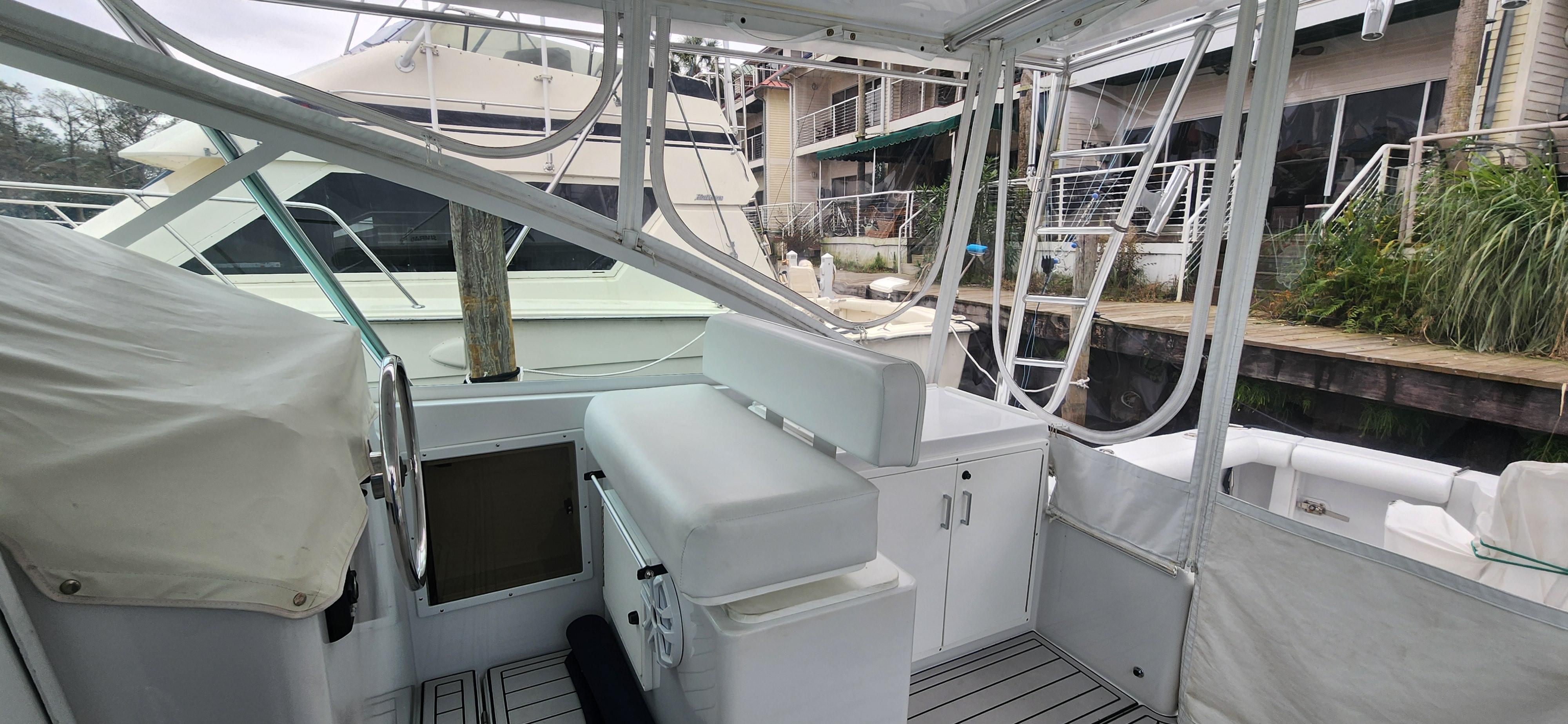Cabo-35 Express 1995 -AL-US-1995 Cabo 35 Express boat interior with seating and helm, docked at marina.-9547451 | Thumbnail