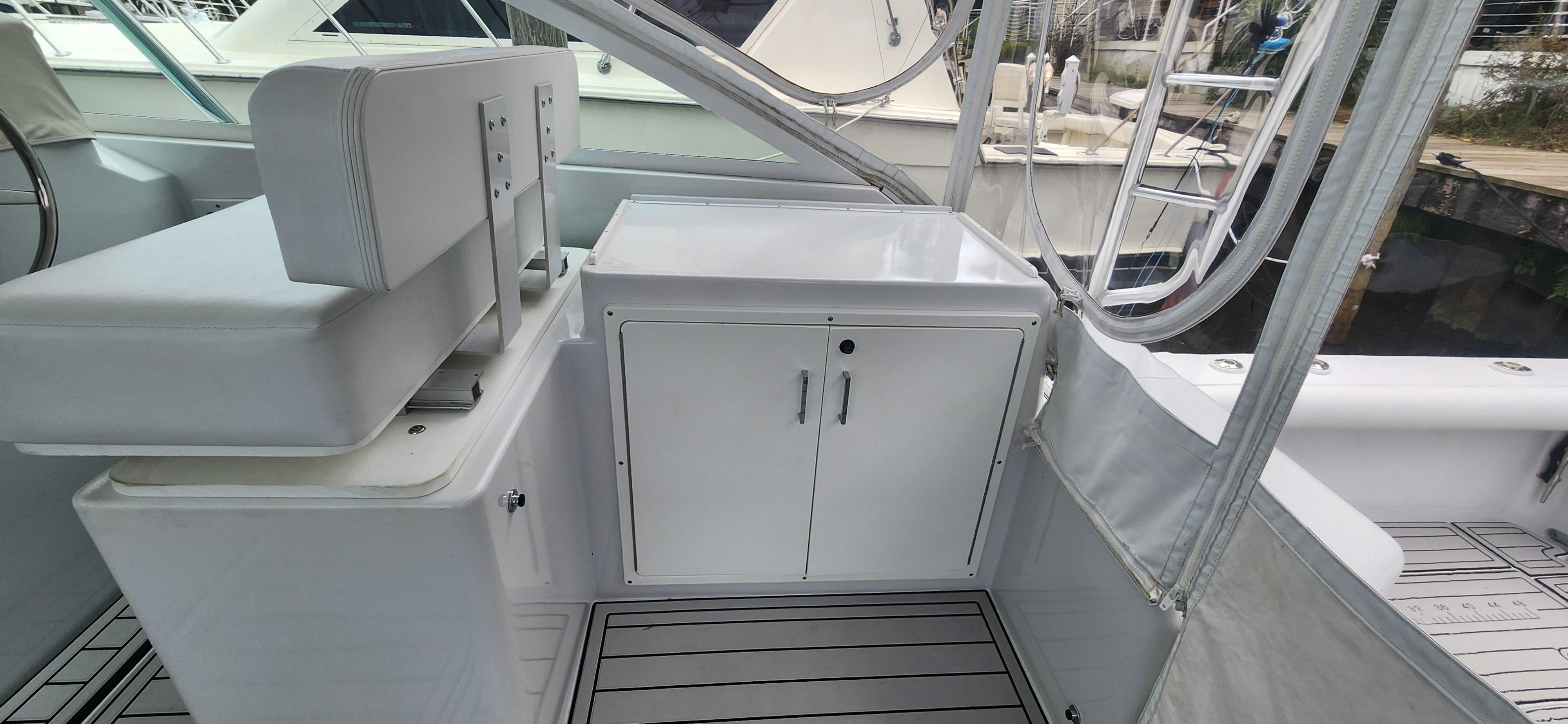 Cabo-35 Express 1995 -AL-US-1995 Cabo 35 Express boat interior with seating and storage cabinet.-9547451 | Thumbnail