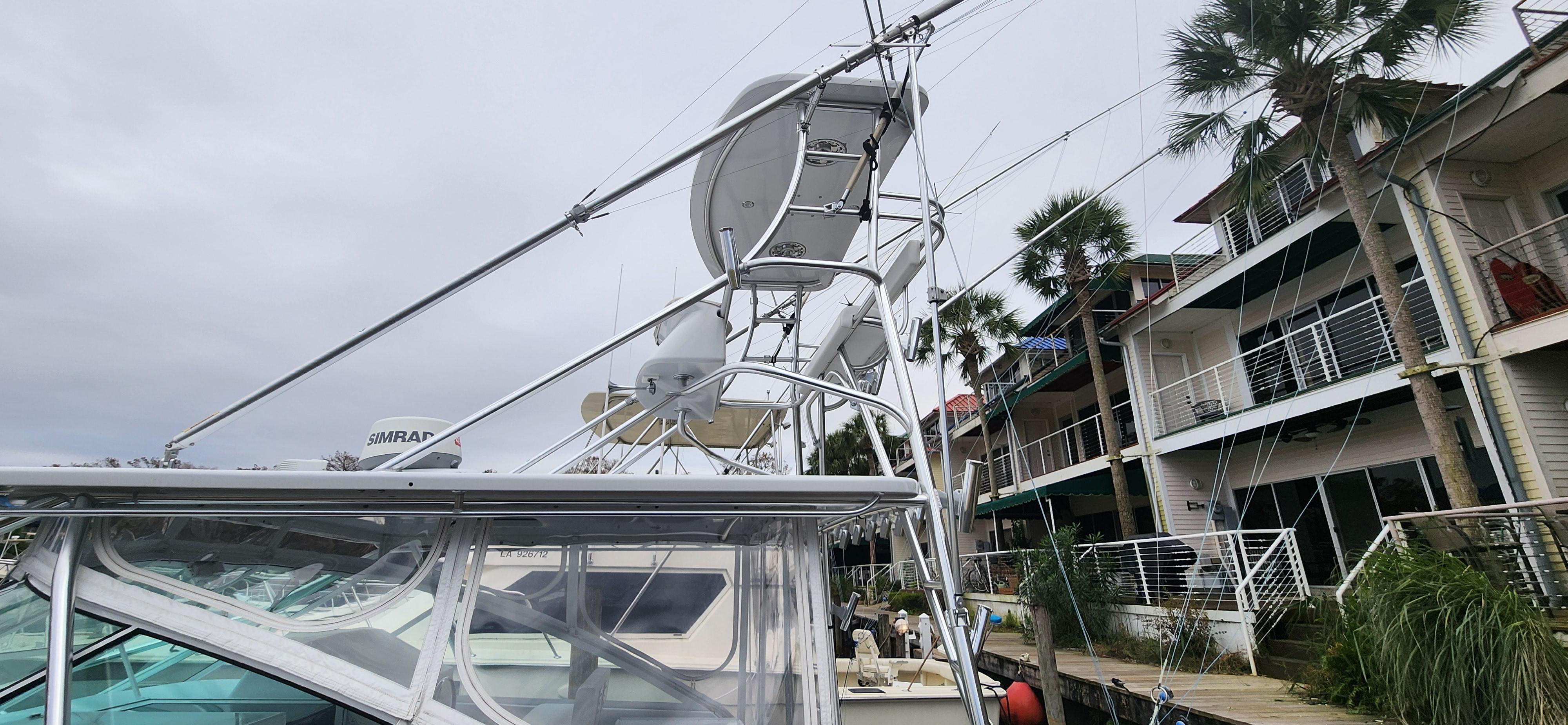 Cabo-35 Express 1995 -AL-US-1995 Cabo 35 Express boat docked near waterfront homes, featuring radar and antennas.-9547451 | Thumbnail