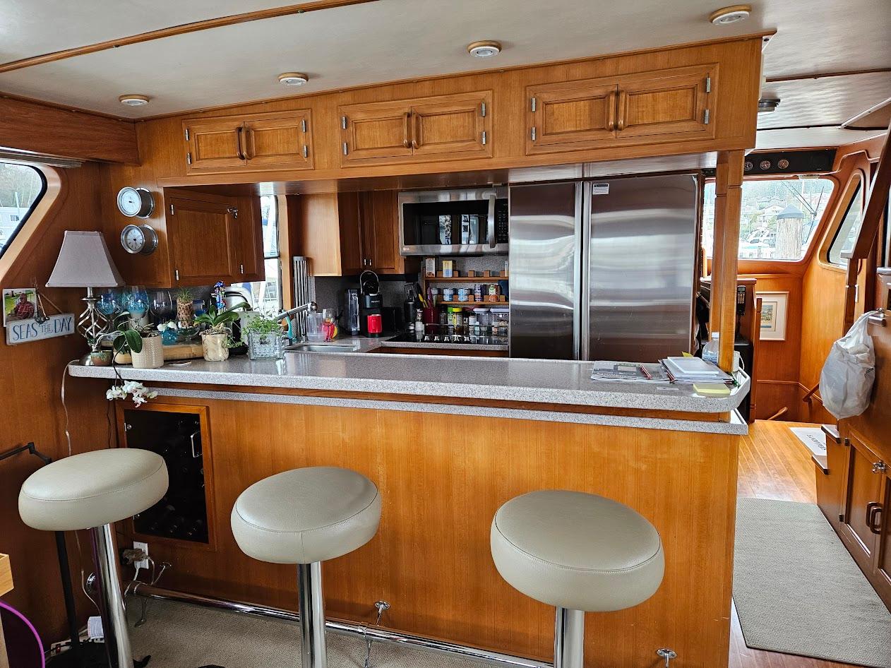 DeFever-53 POC 1987 -WA-US-Interior of 1987 DeFever 53 POC yacht with kitchen and bar stools.-9787461 | Thumbnail