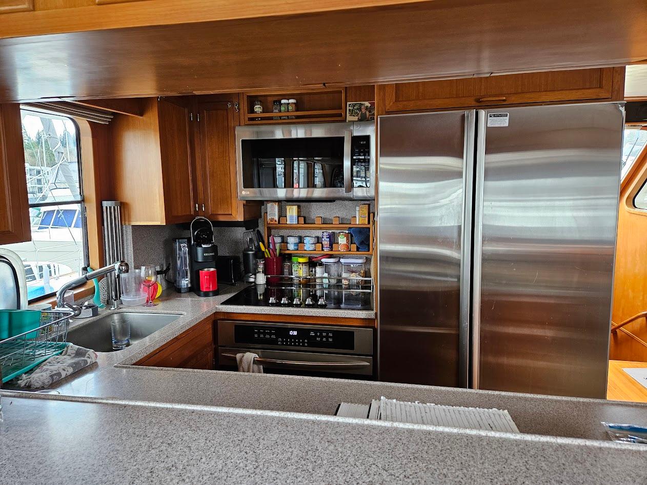 DeFever-53 POC 1987 -WA-US-Kitchen interior of 1987 DeFever 53 POC yacht with modern appliances and wooden cabinetry.-9787461 | Thumbnail