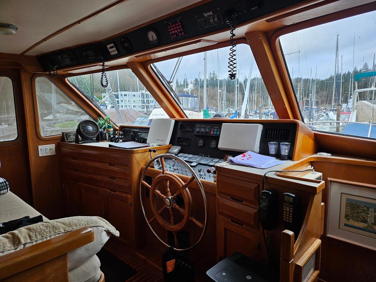 DeFever-53 POC 1987 -WA-US-Interior of 1987 DeFever 53 POC yacht helm with wooden steering wheel and navigation equipment.-9787461 | Thumbnail