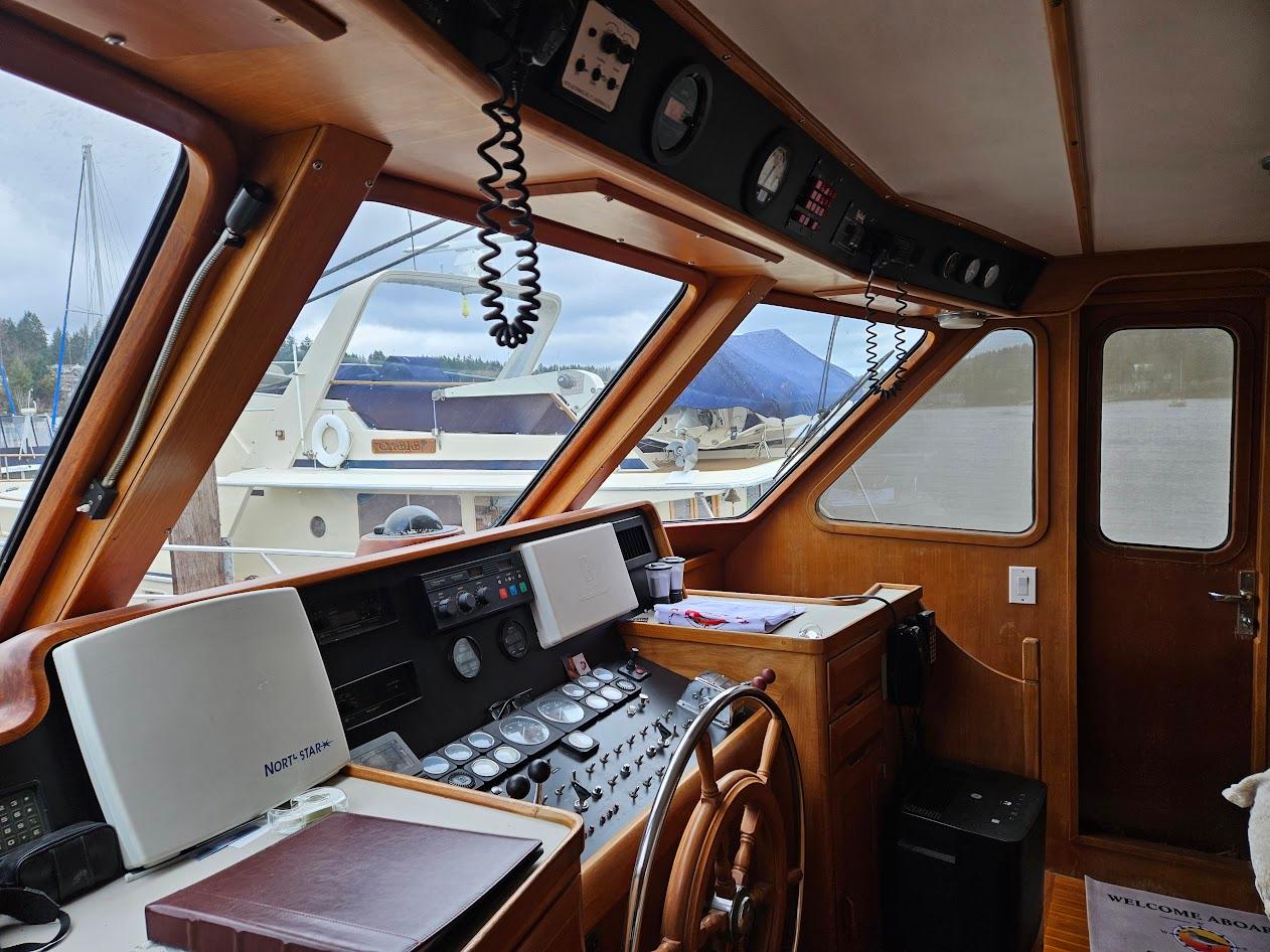DeFever-53 POC 1987 -WA-US-1987 DeFever 53 POC yacht helm with wooden steering wheel and navigation instruments.-9787461 | Thumbnail