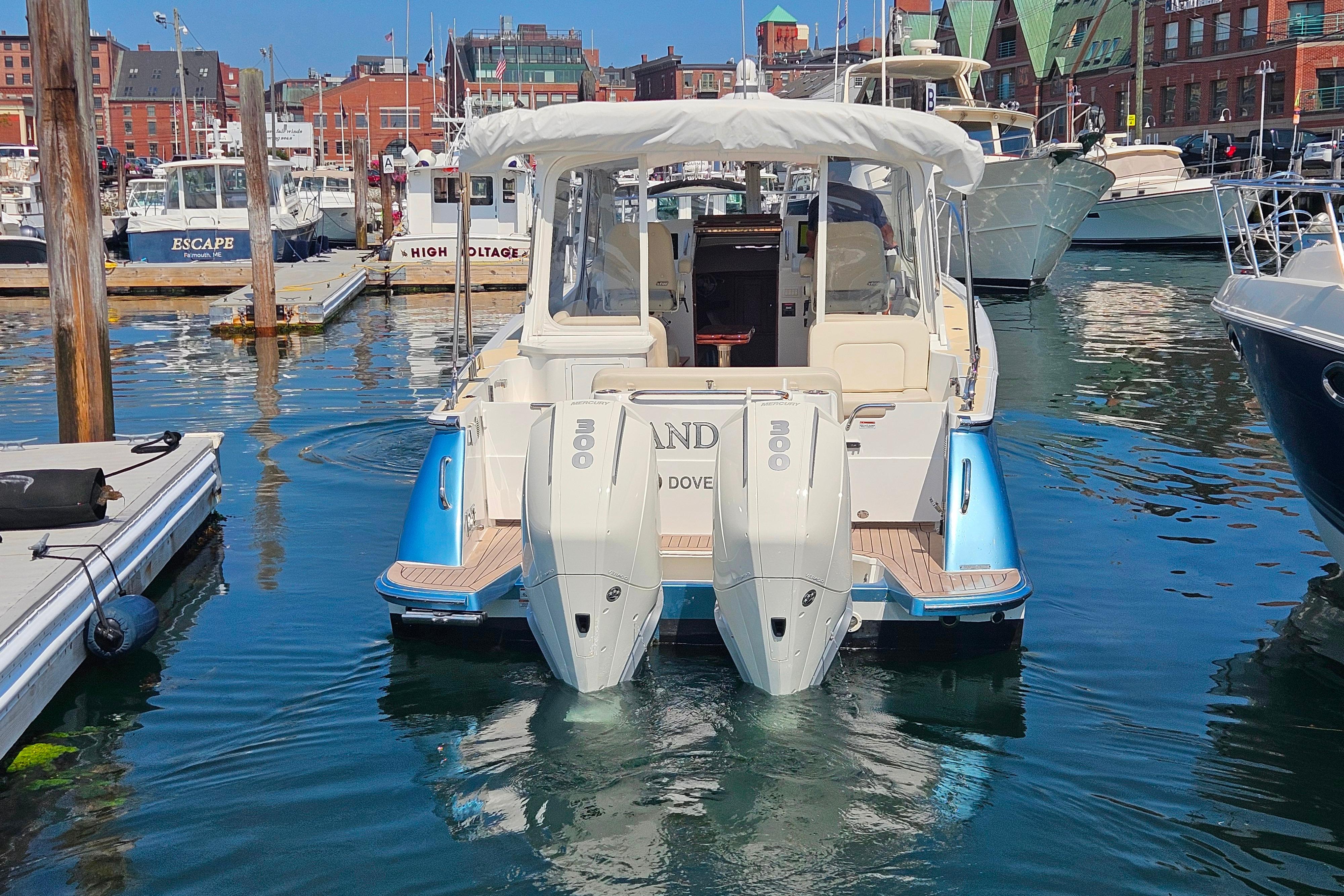 2023 MJM 35 boat docked in a marina with twin outboard engines.