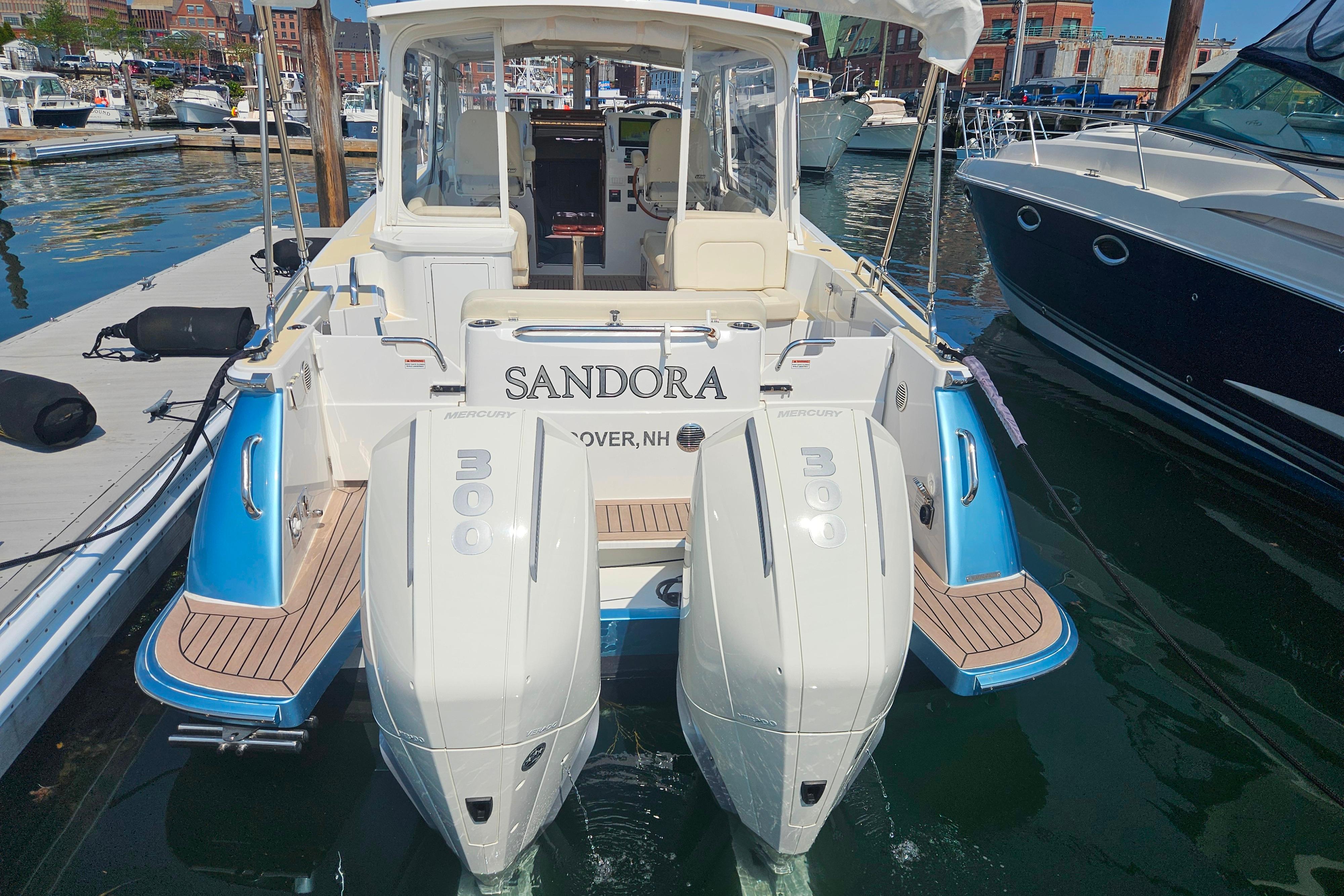 2023 MJM 35 boat with twin Mercury 300 engines docked at a marina.