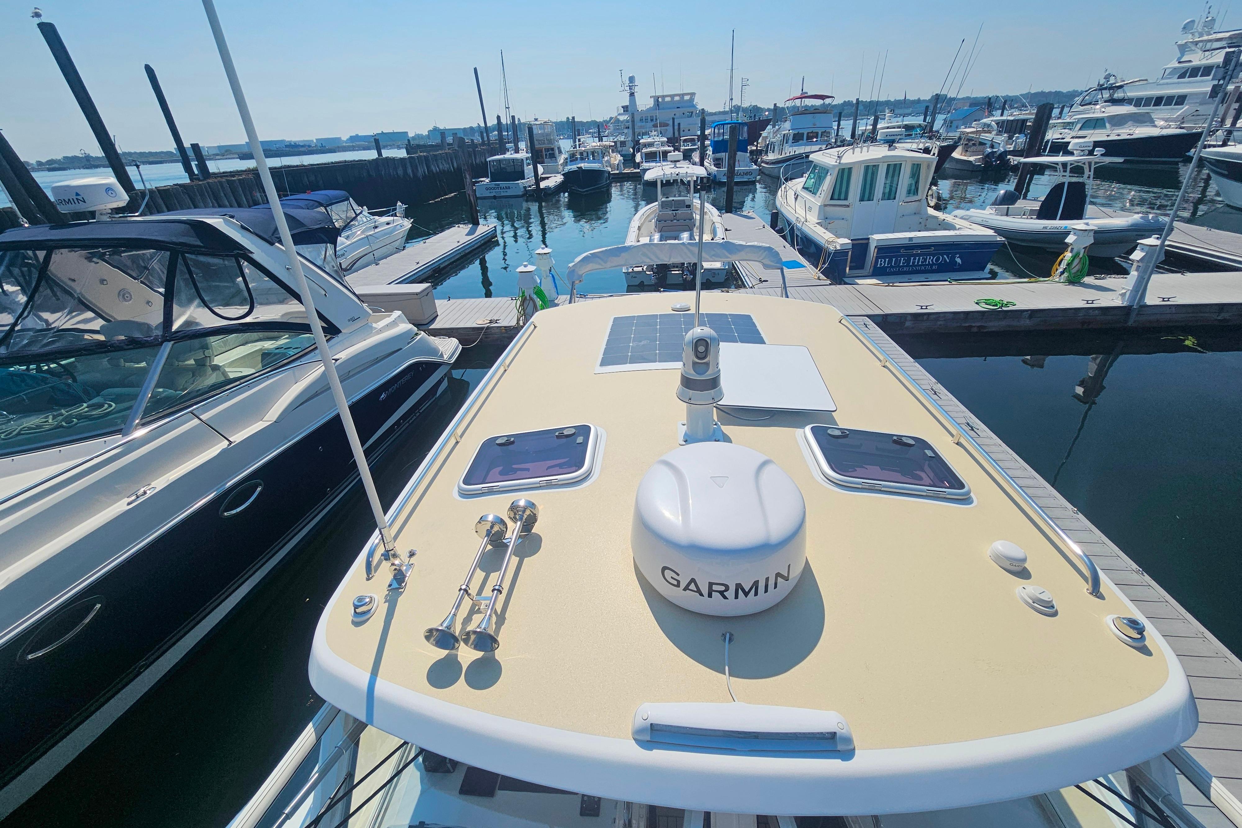 2023 MJM 35 yacht docked at marina, featuring Garmin equipment on deck.