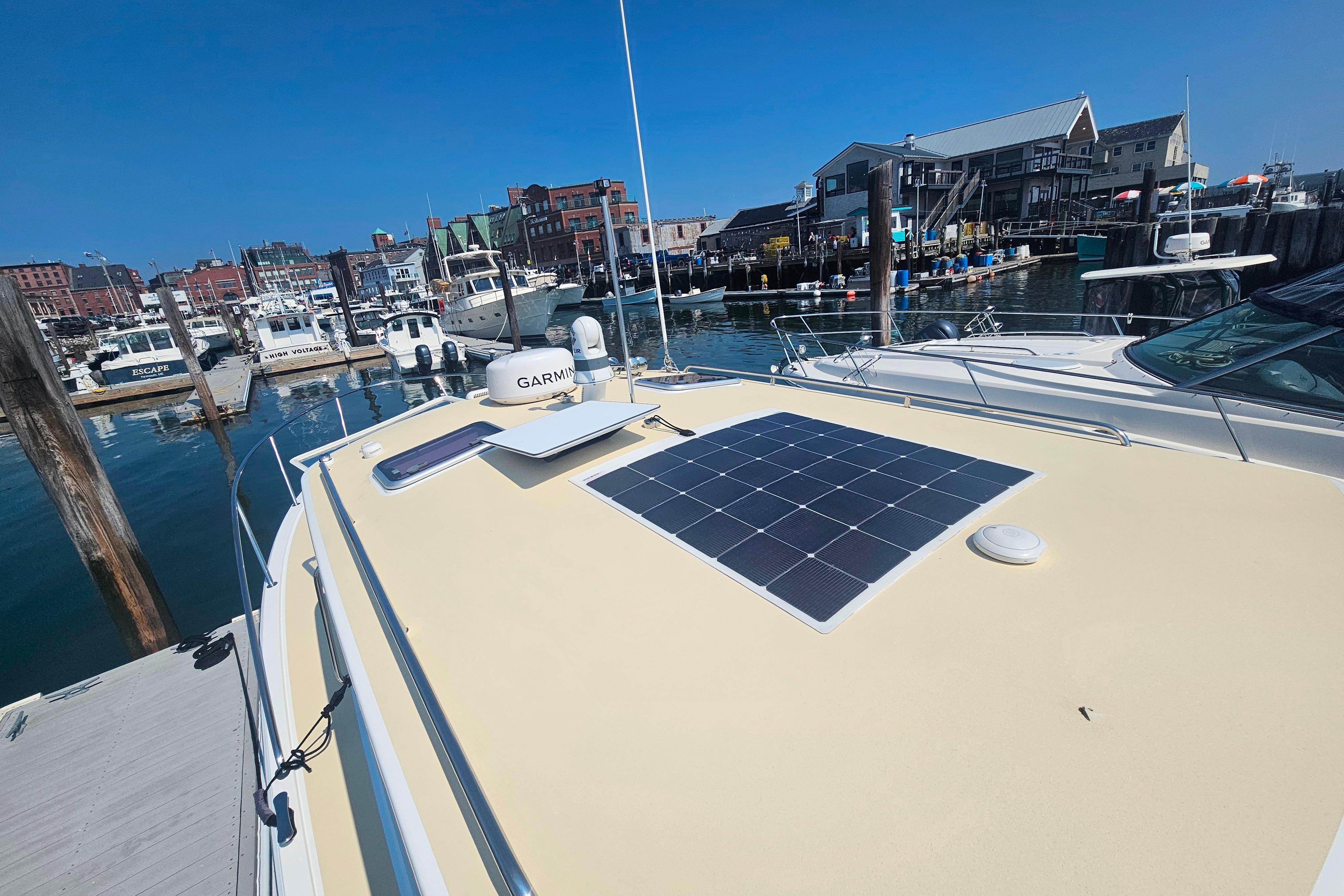 2023 MJM 35 boat with solar panel docked at a marina.