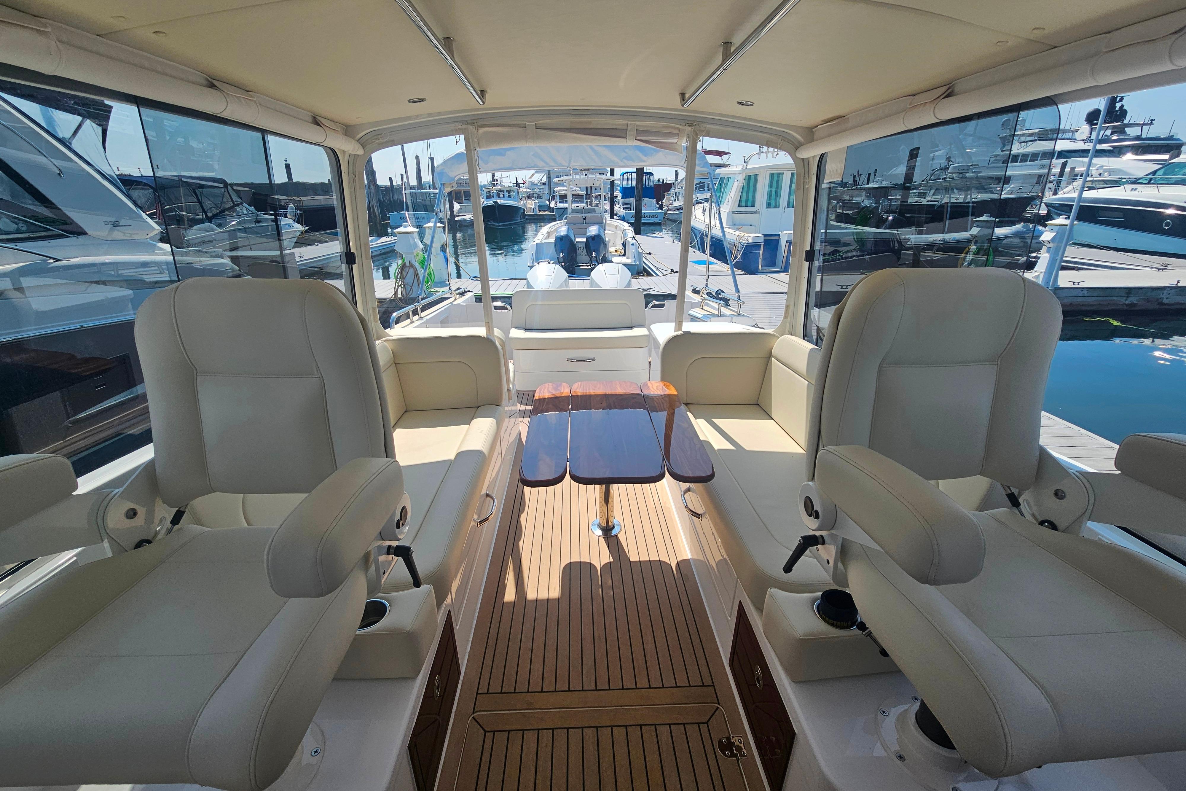 Luxurious interior of 2023 MJM 35 yacht with plush seating and wooden flooring.