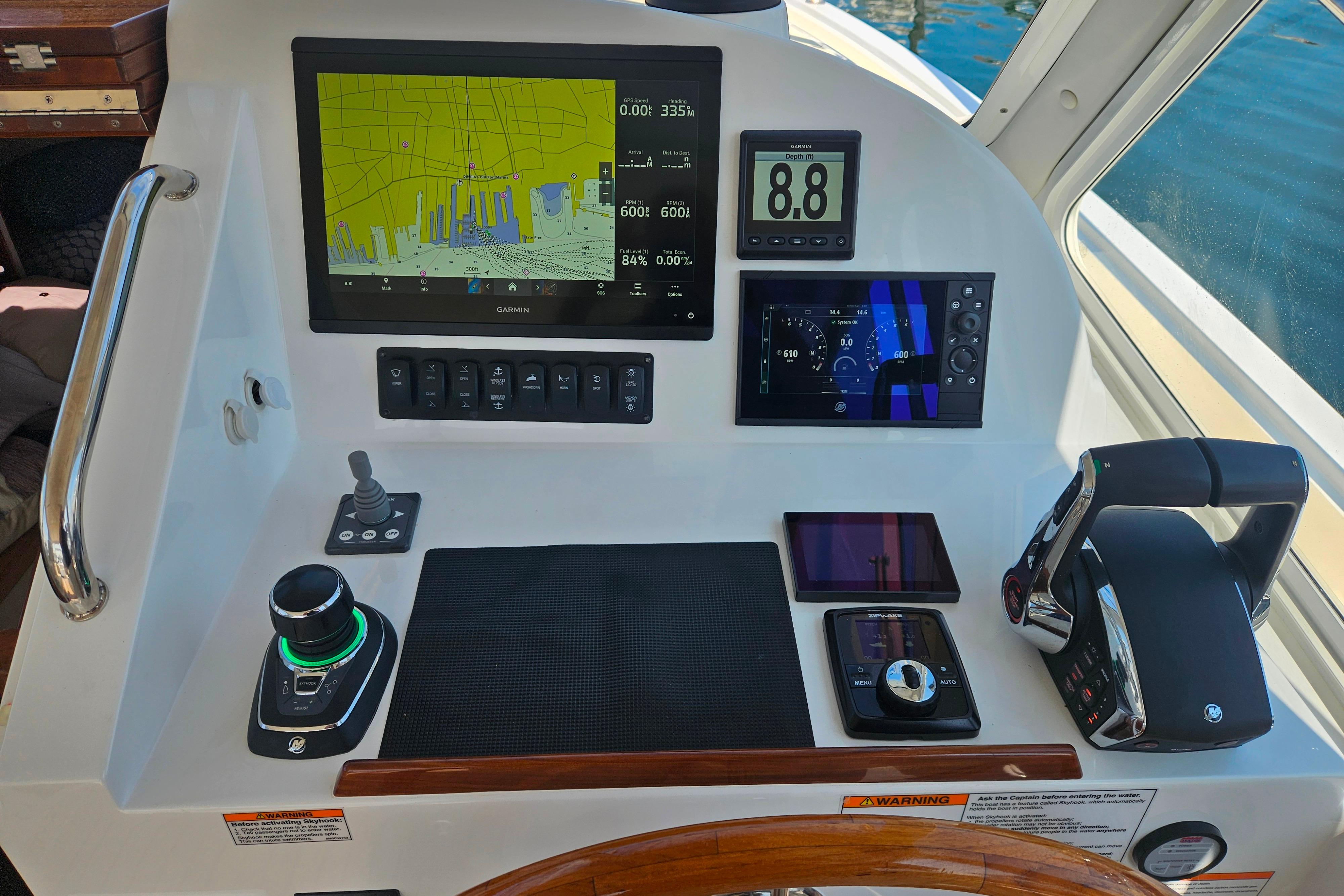 Control panel of 2023 MJM 35 boat with navigation and throttle systems.