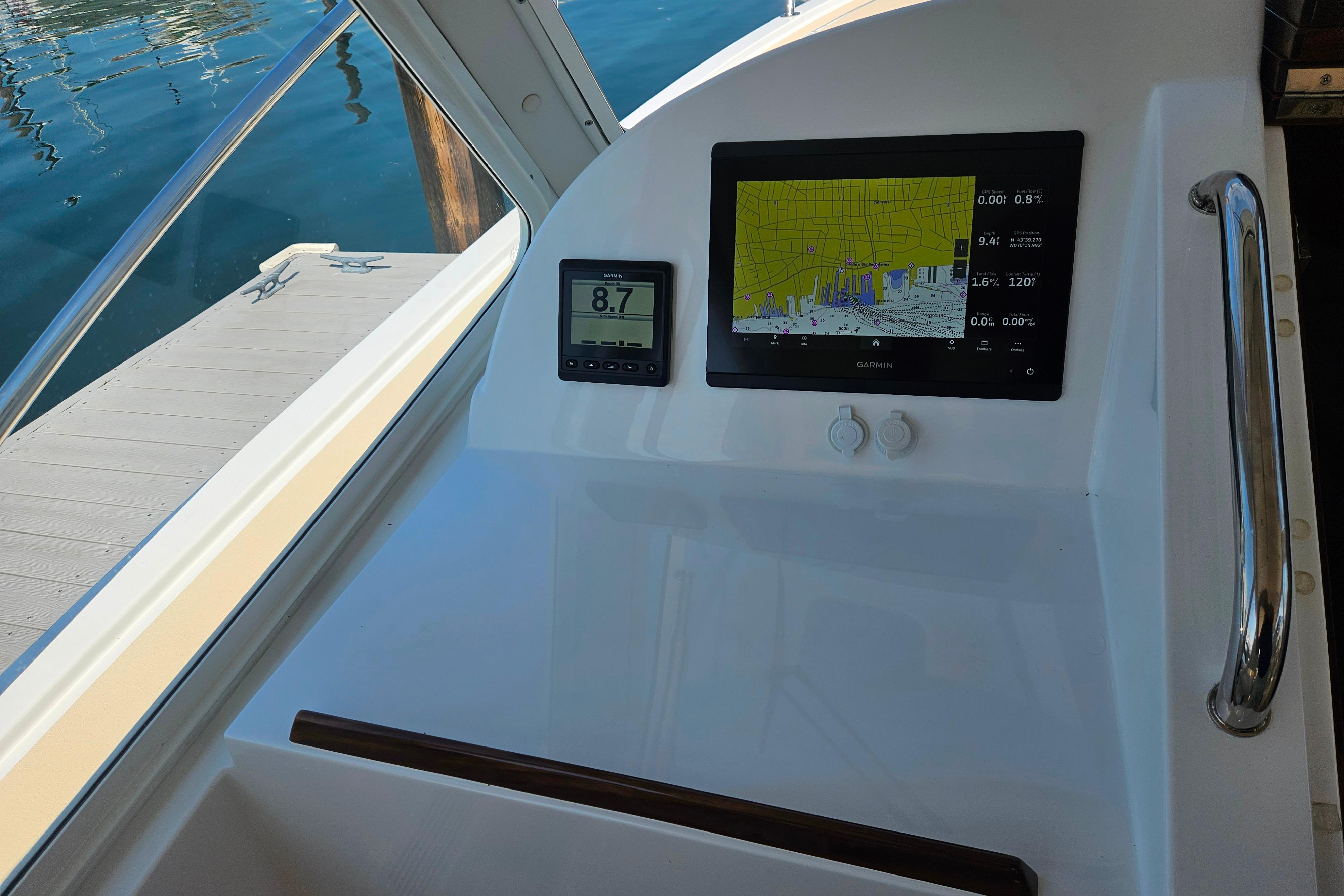 2023 MJM 35 boat dashboard with Garmin navigation display and speedometer.
