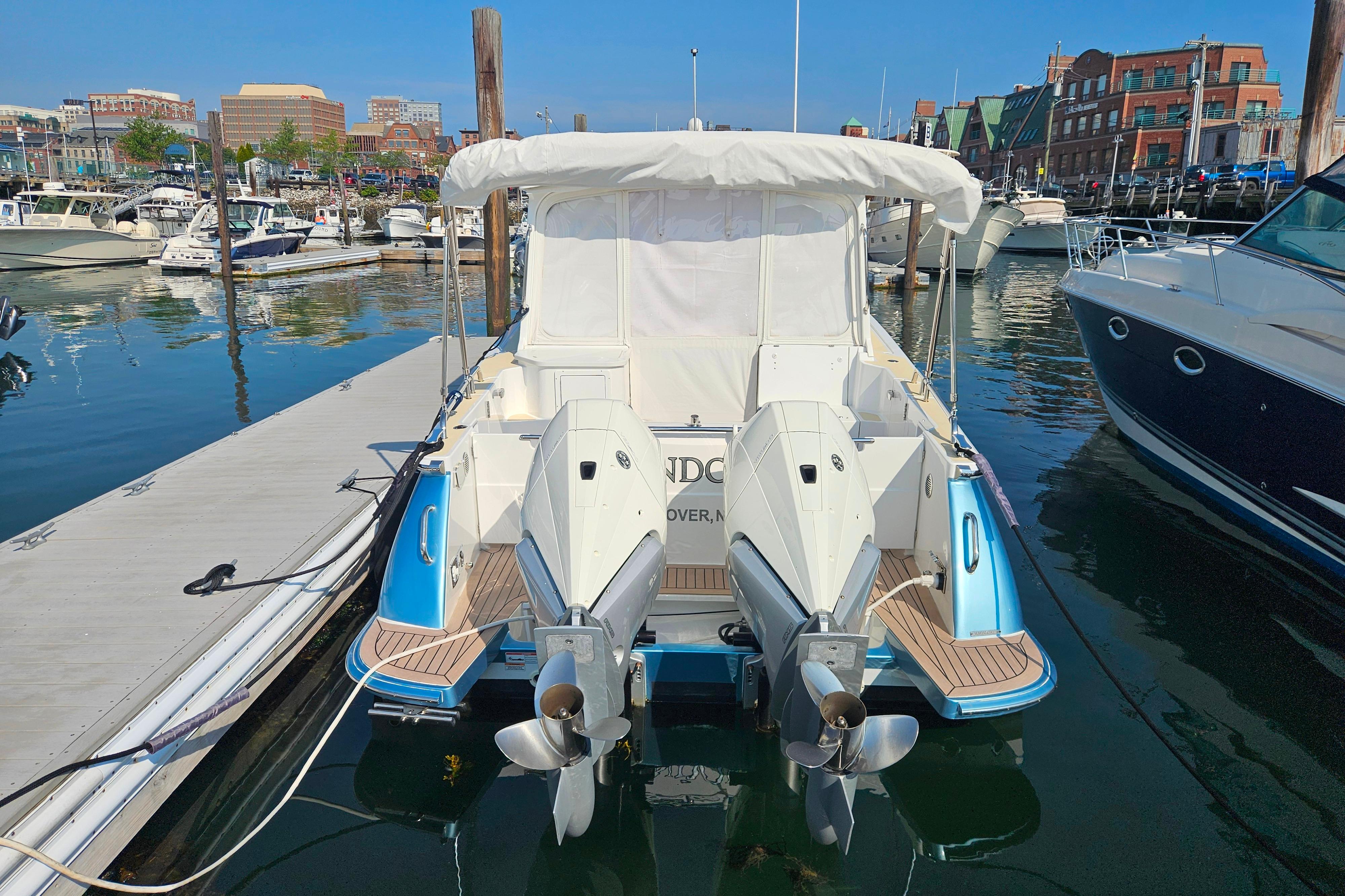 2023 MJM 35 boat docked at marina with twin outboard engines.