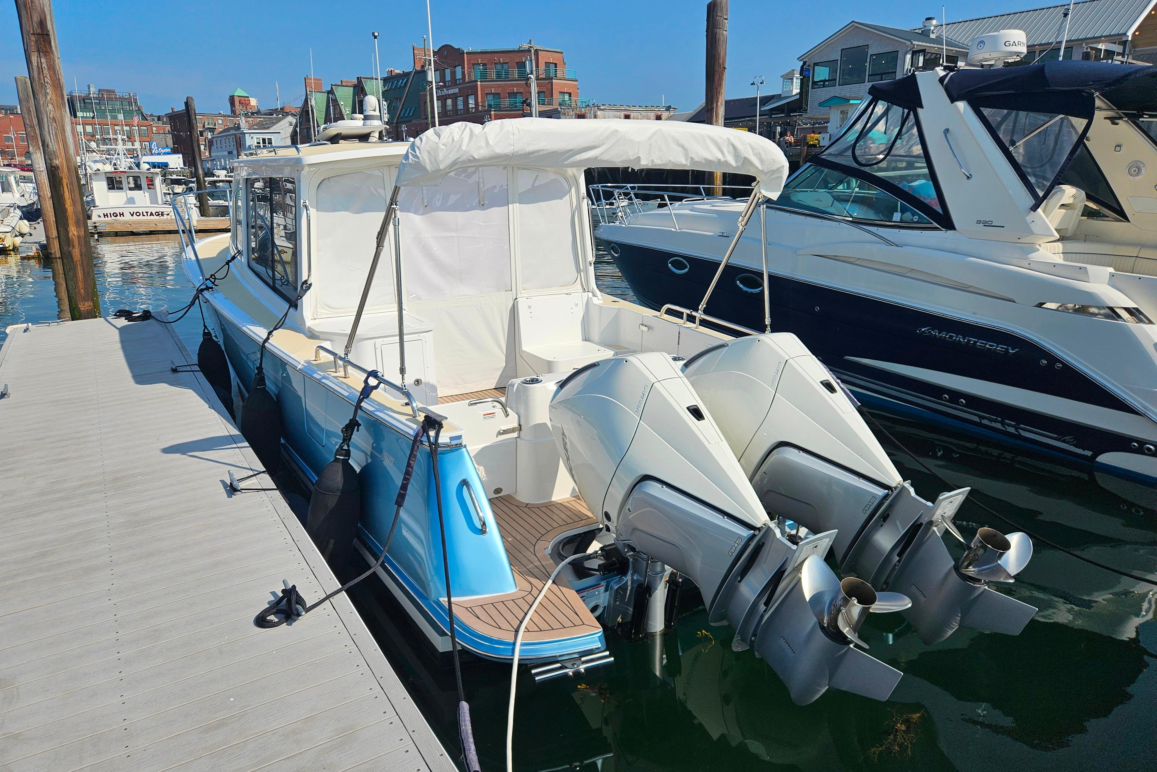 2023 MJM 35 boat docked with twin outboard engines in a marina setting.