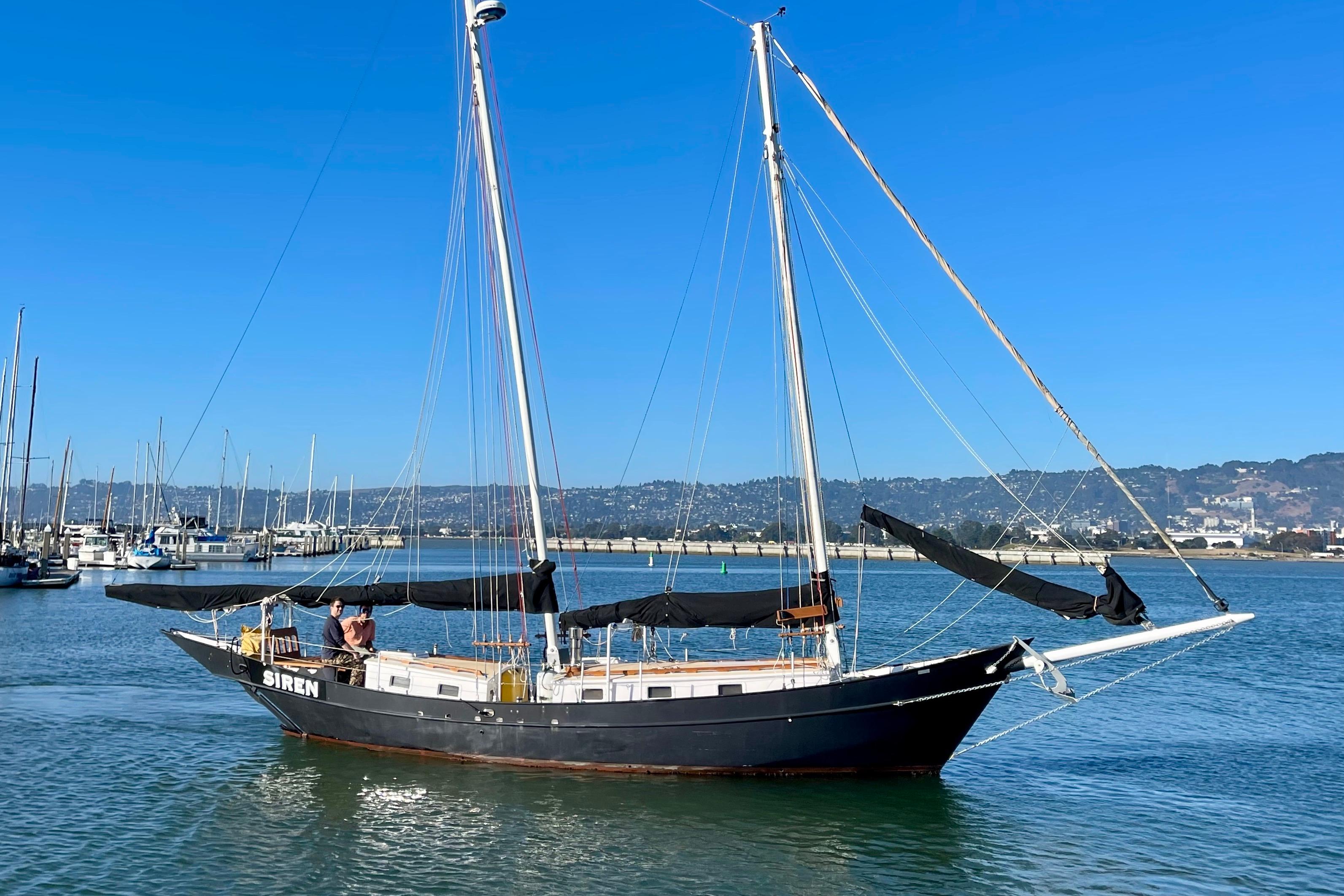Sailboat "Siren" on calm waters, Custom Pinky model, 2008, with clear blue sky.
