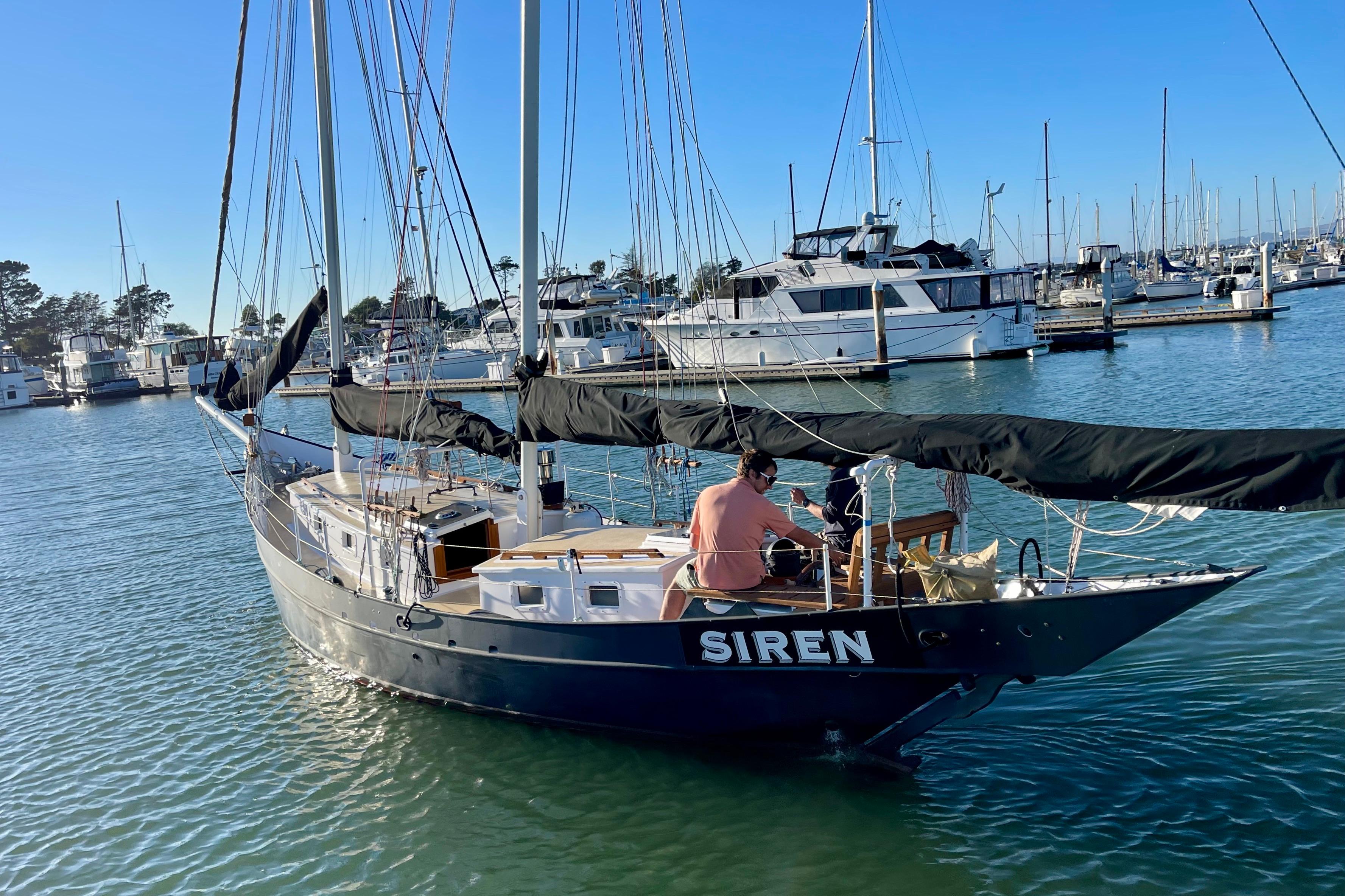 Sailboat "Siren" by Pinky, Custom model, 2008, docked in a marina under clear skies.