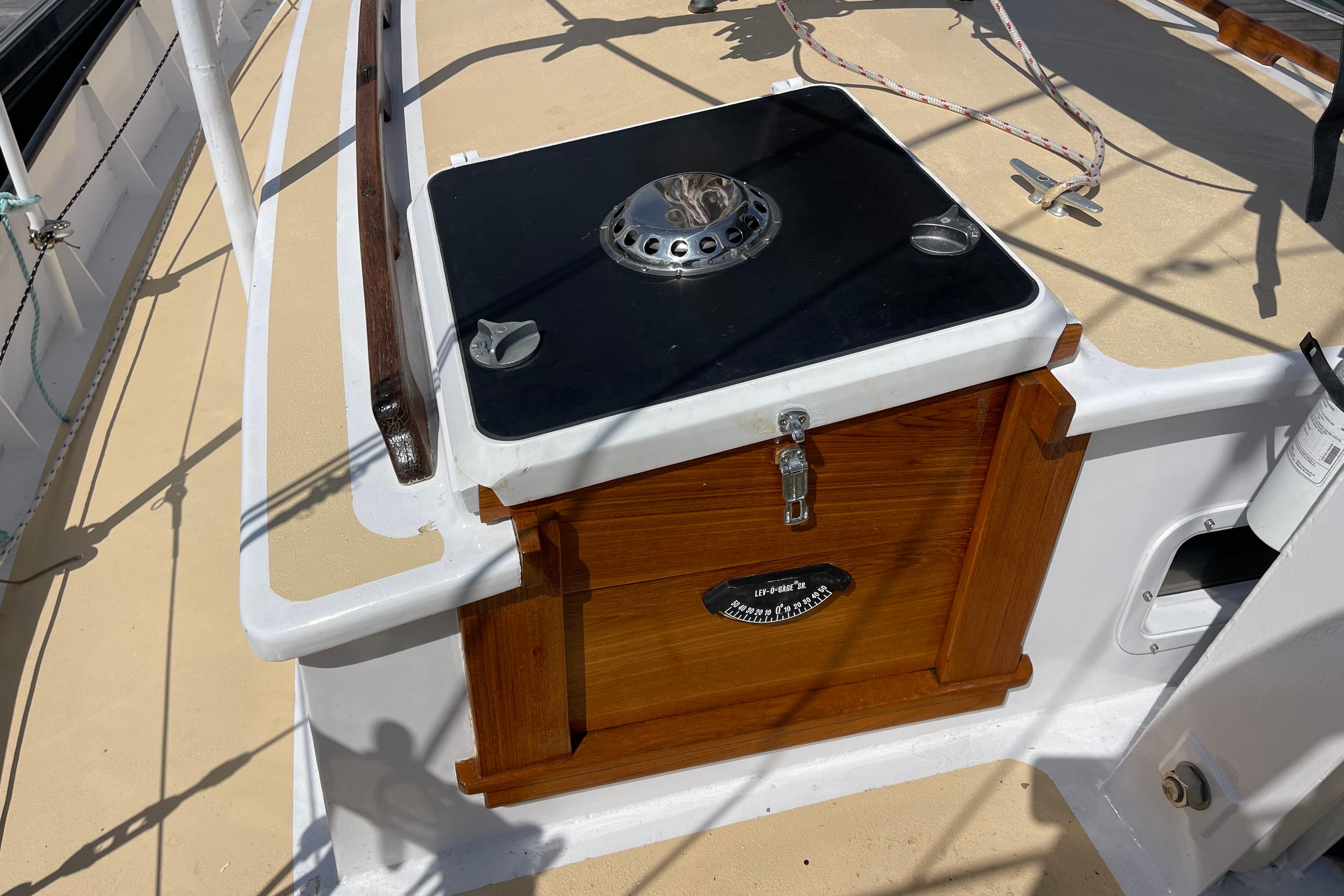 Wooden deck feature on 2008 Pinky Custom boat with metal fixture and latch.