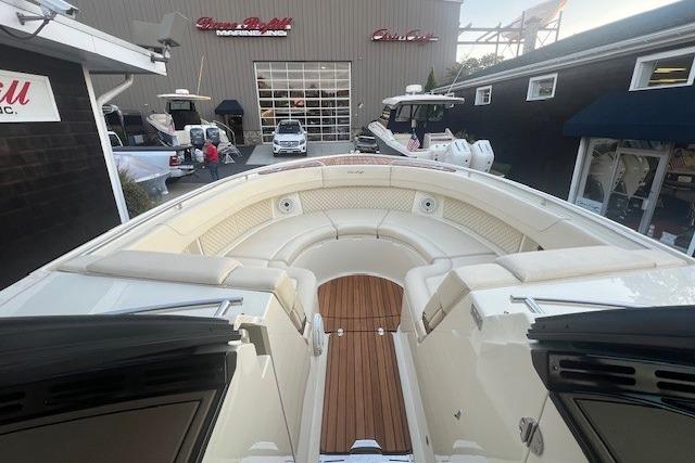 2024 Chris-Craft Calypso 35 boat interior with luxurious seating and wooden flooring.