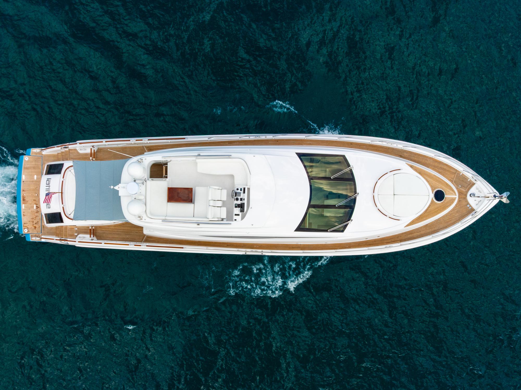 Picture of LATITUDE Lazzara 78 ft' 78 LSX TWIN ENGINES Overhead view of 2010 Lazzara 78 LSX yacht cruising on blue ocean waters. 