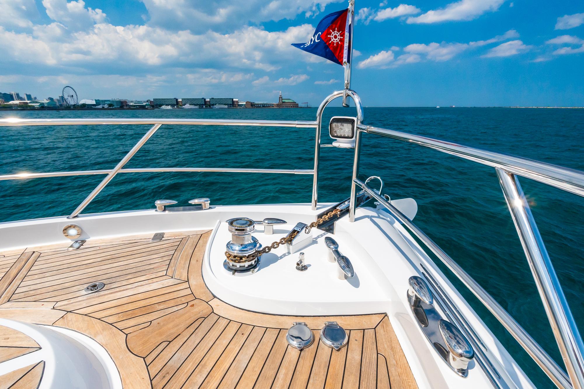 Lazzara-78 LSX TWIN ENGINES 2010-LATITUDE IL-US-Bow of 2010 Lazzara 78 LSX yacht with wooden deck, cruising on blue ocean.-9307533 | Thumbnail
