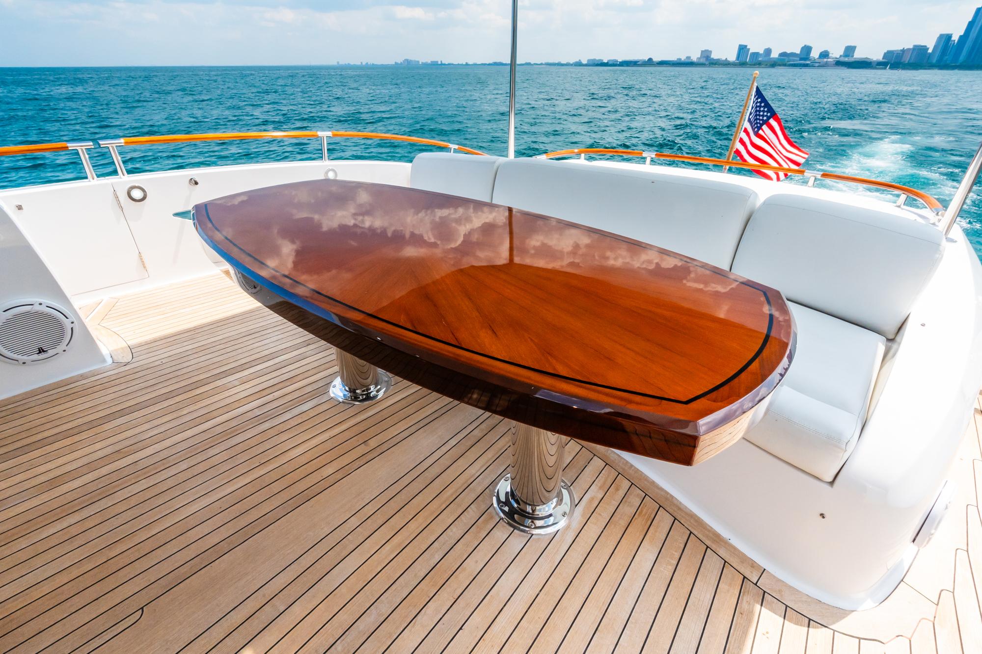 Lazzara-78 LSX TWIN ENGINES 2010-LATITUDE IL-US-Luxury yacht deck with polished wood table, white seating, and ocean view. Lazzara 78 LSX, 2010.-9307533 | Thumbnail
