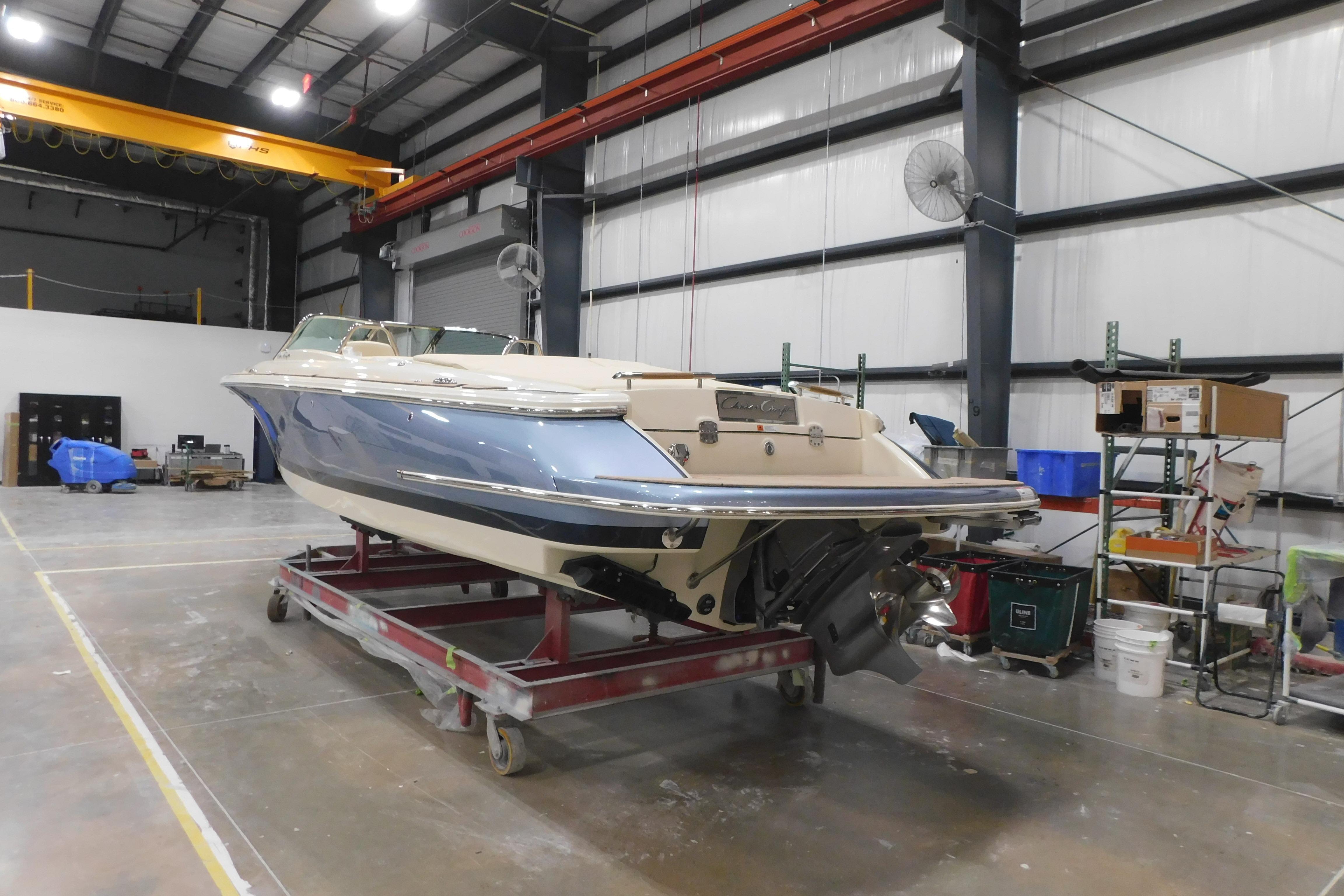 2026 Chris-Craft Launch 27 boat in a warehouse setting.