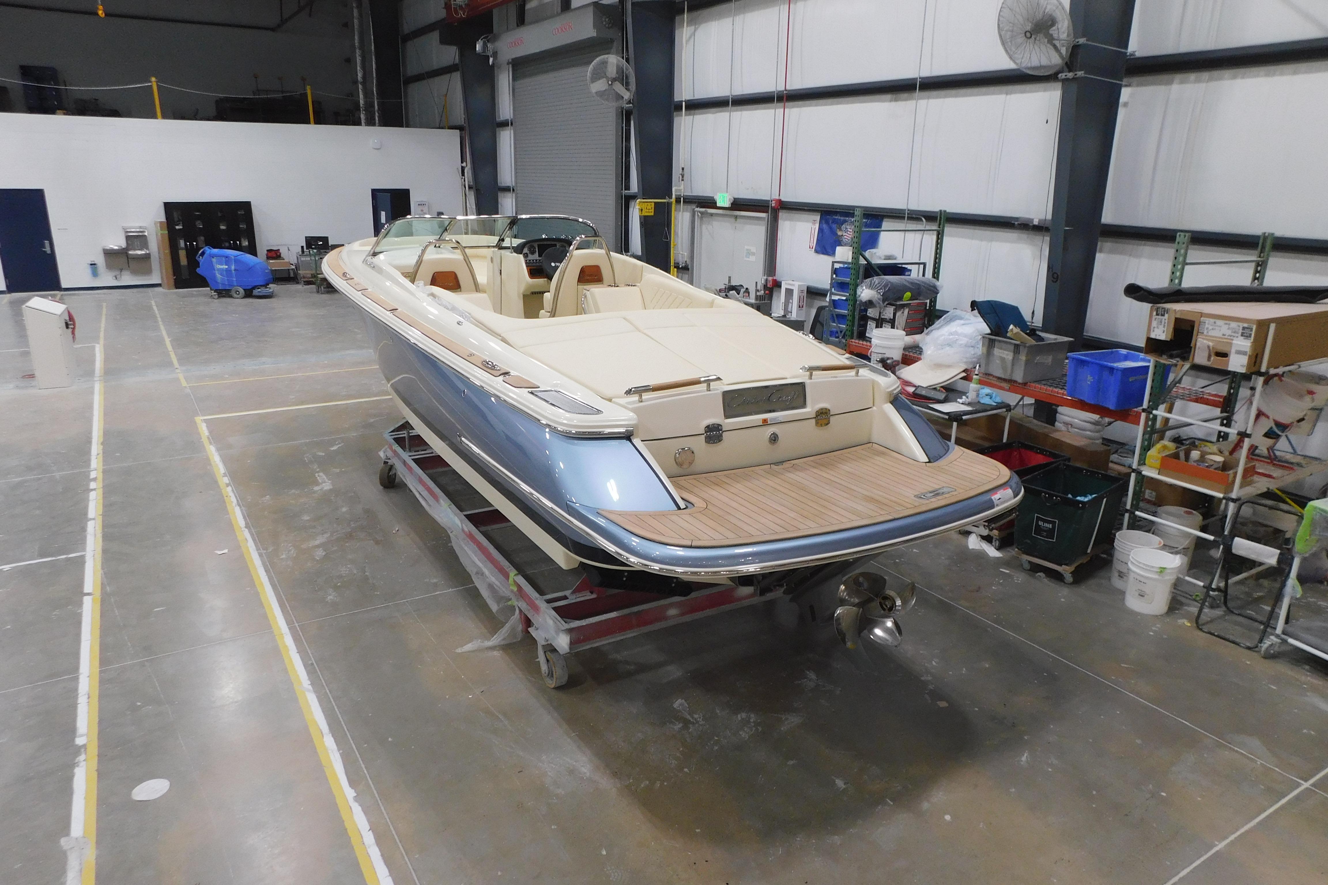 2026 Chris-Craft Launch 27 boat in a warehouse setting, showcasing luxury design.