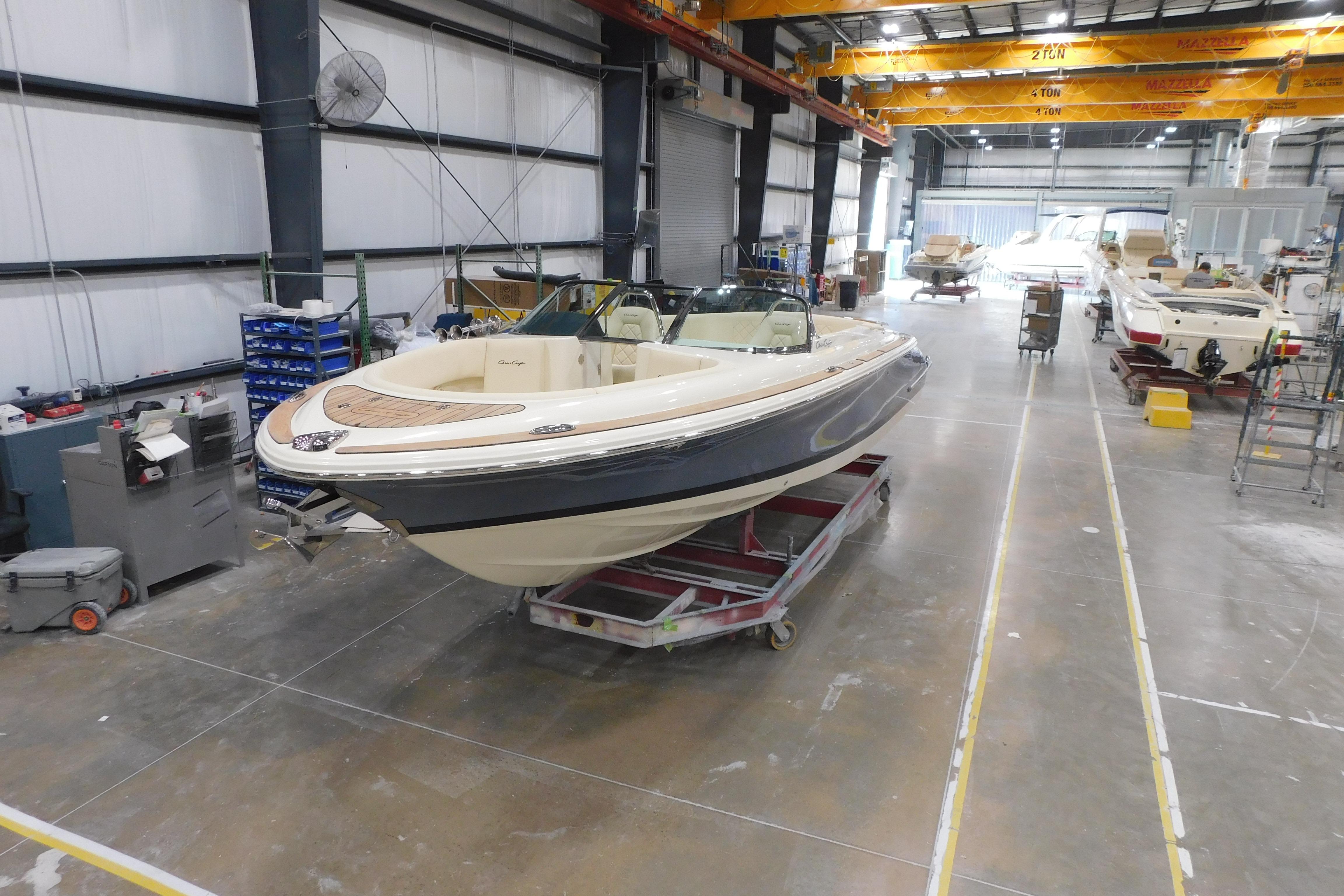 2026 Chris-Craft Launch 27 boat in a manufacturing facility.