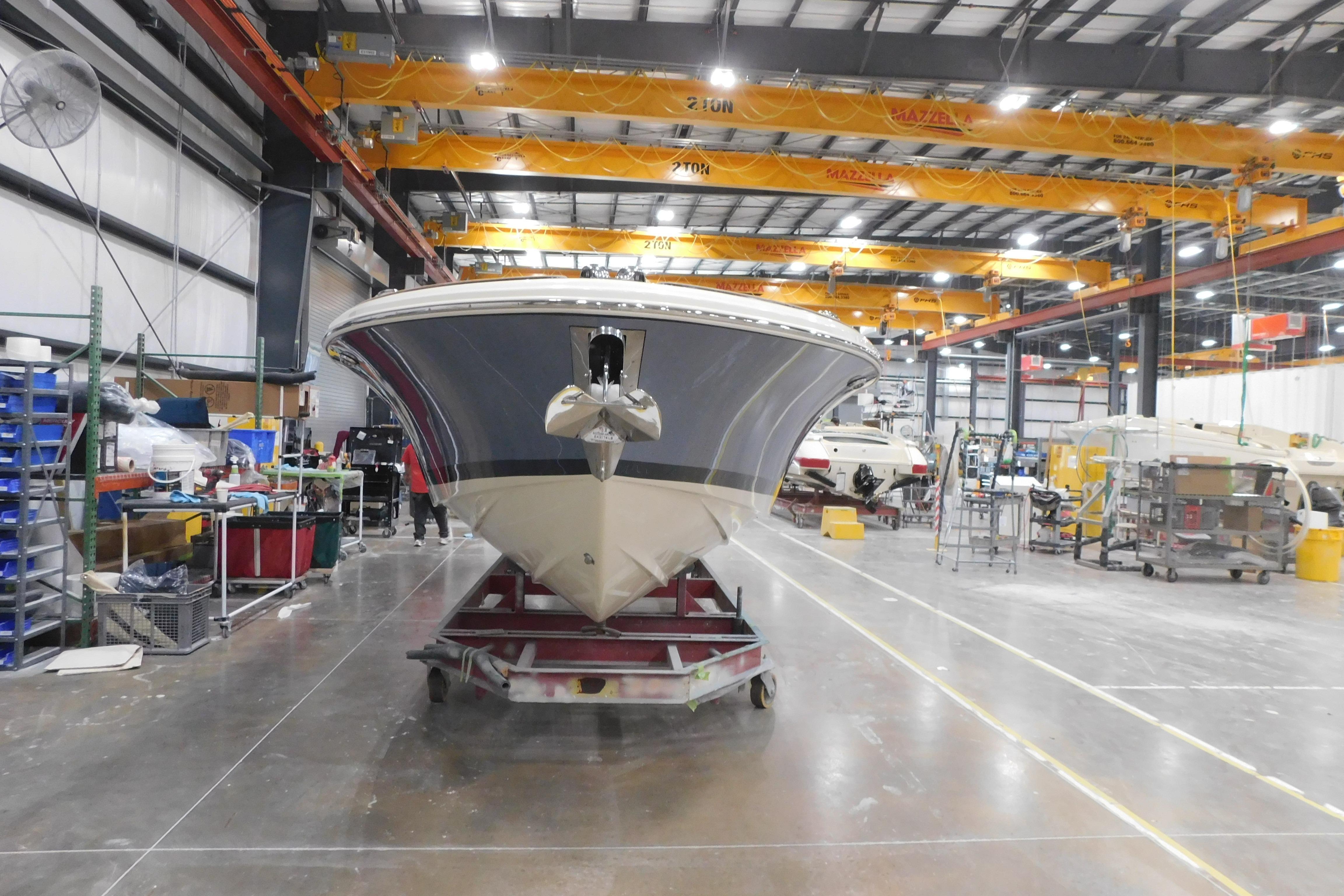 2026 Chris-Craft Launch 27 boat in a manufacturing facility.