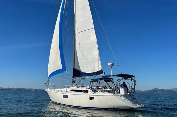 Sailing yacht Gib'Sea 126, 1985 model, cruising on open water under clear blue skies.