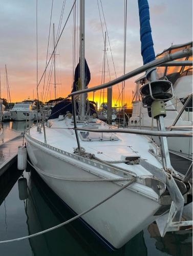 1985 Gib'Sea 126 sailboat docked at sunset, reflecting on calm water.