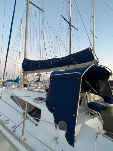 1985 Gib'Sea 126 sailboat with blue canopy and sails docked at marina.