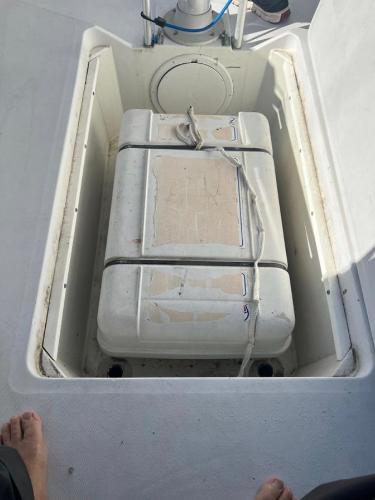 Storage compartment on 1985 Gib'Sea 126 sailboat with secured equipment.