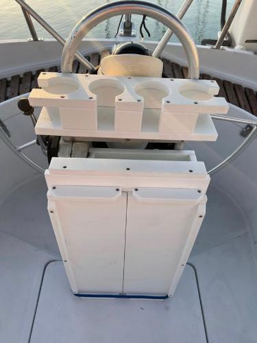 Cockpit of 1985 Gib'Sea 126 sailboat with steering wheel and cup holders.