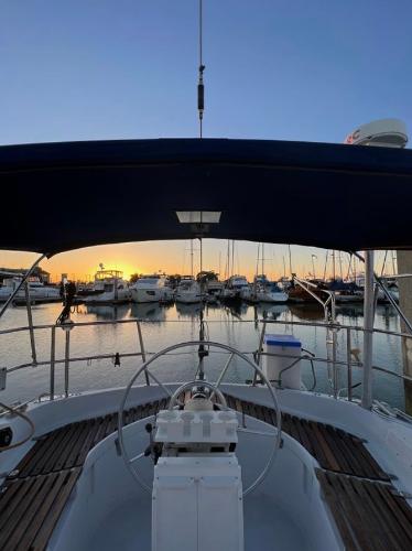 Sailboat cockpit view at sunset, Gib'Sea 126, 1985 model, marina background.
