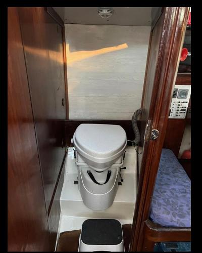 1985 Gib'Sea 126 yacht bathroom with compact marine toilet.