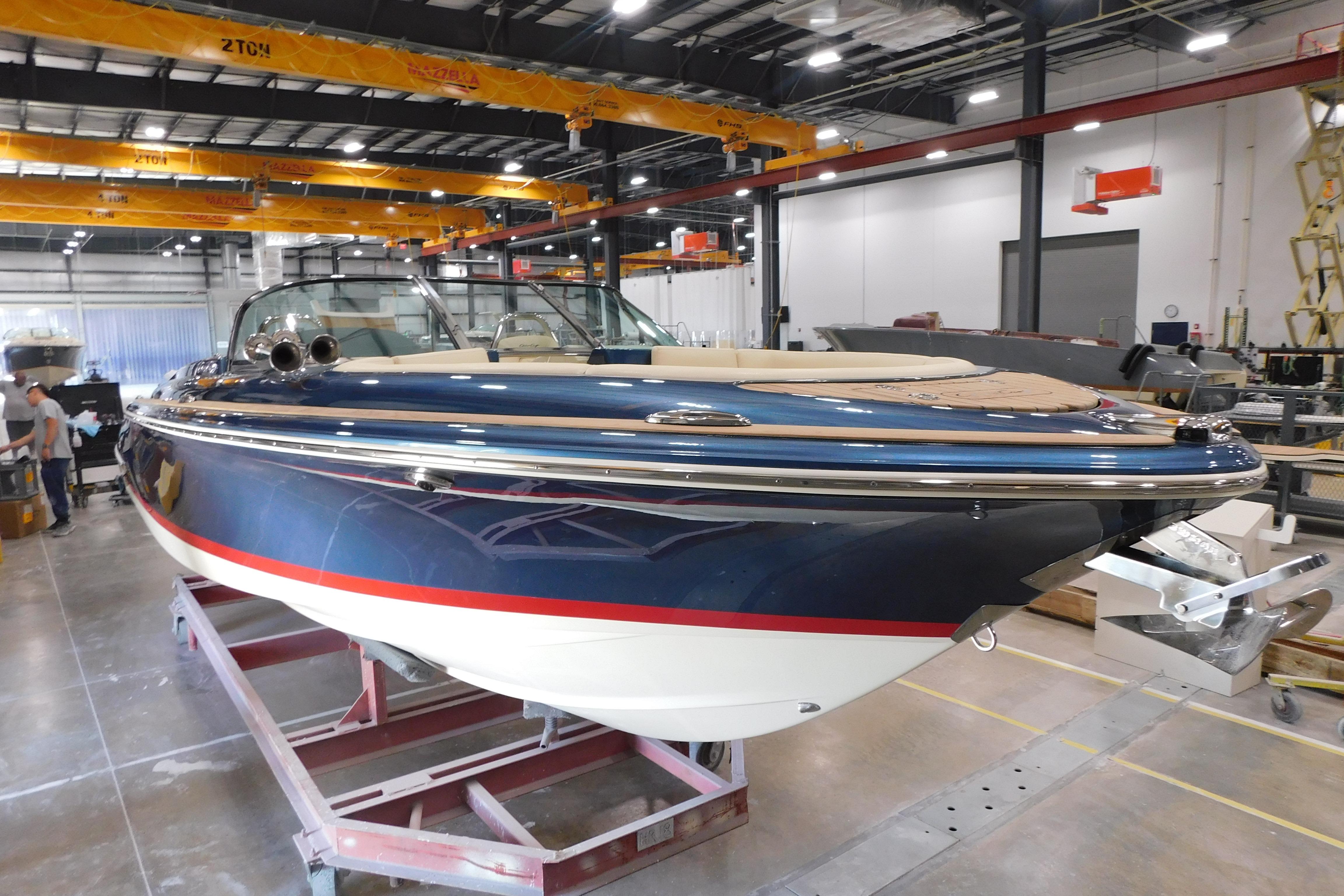 2025 Chris-Craft Launch 27 boat in a manufacturing facility, showcasing sleek design and craftsmanship.