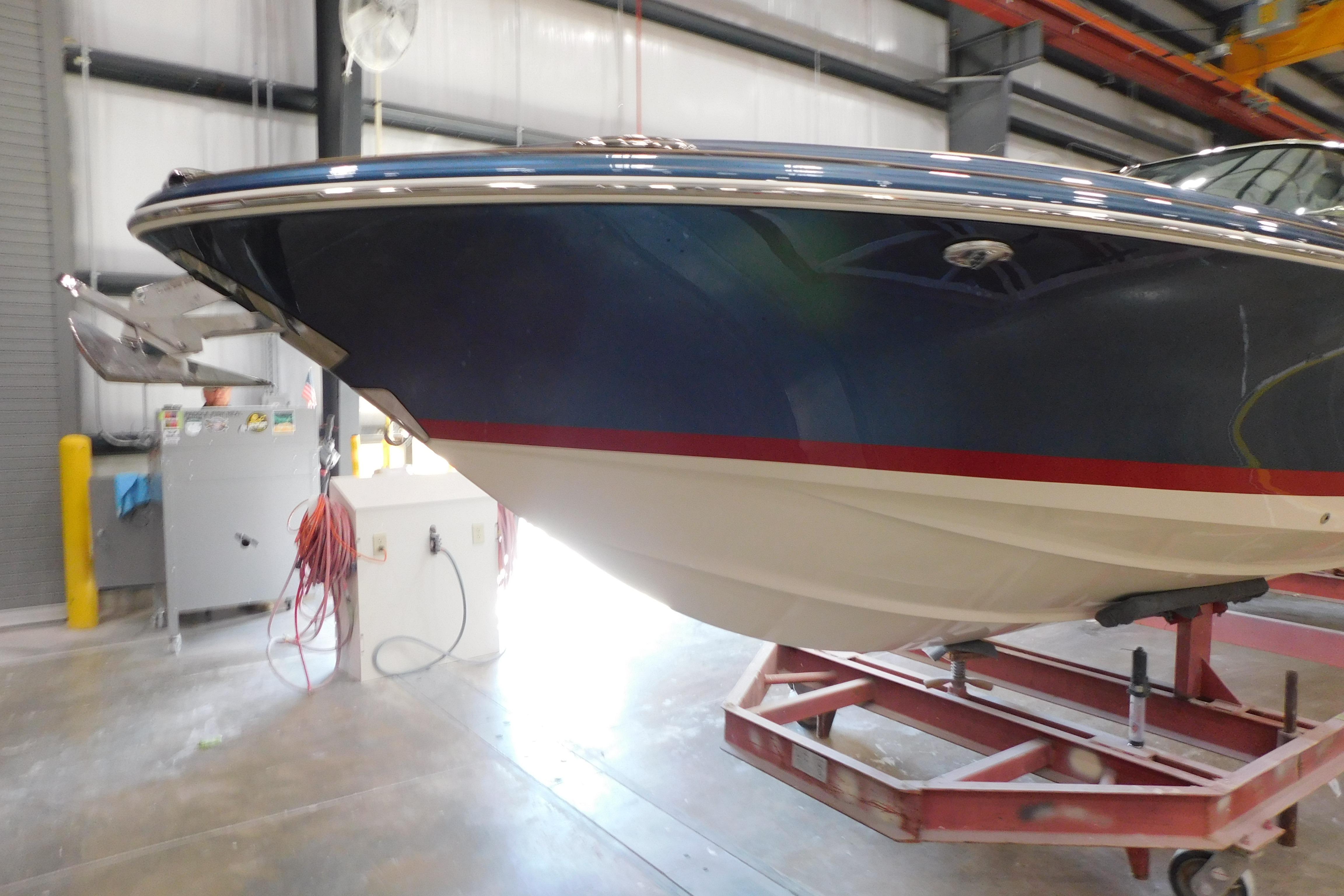 2025 Chris-Craft Launch 27 boat in a workshop, showcasing sleek design and craftsmanship.