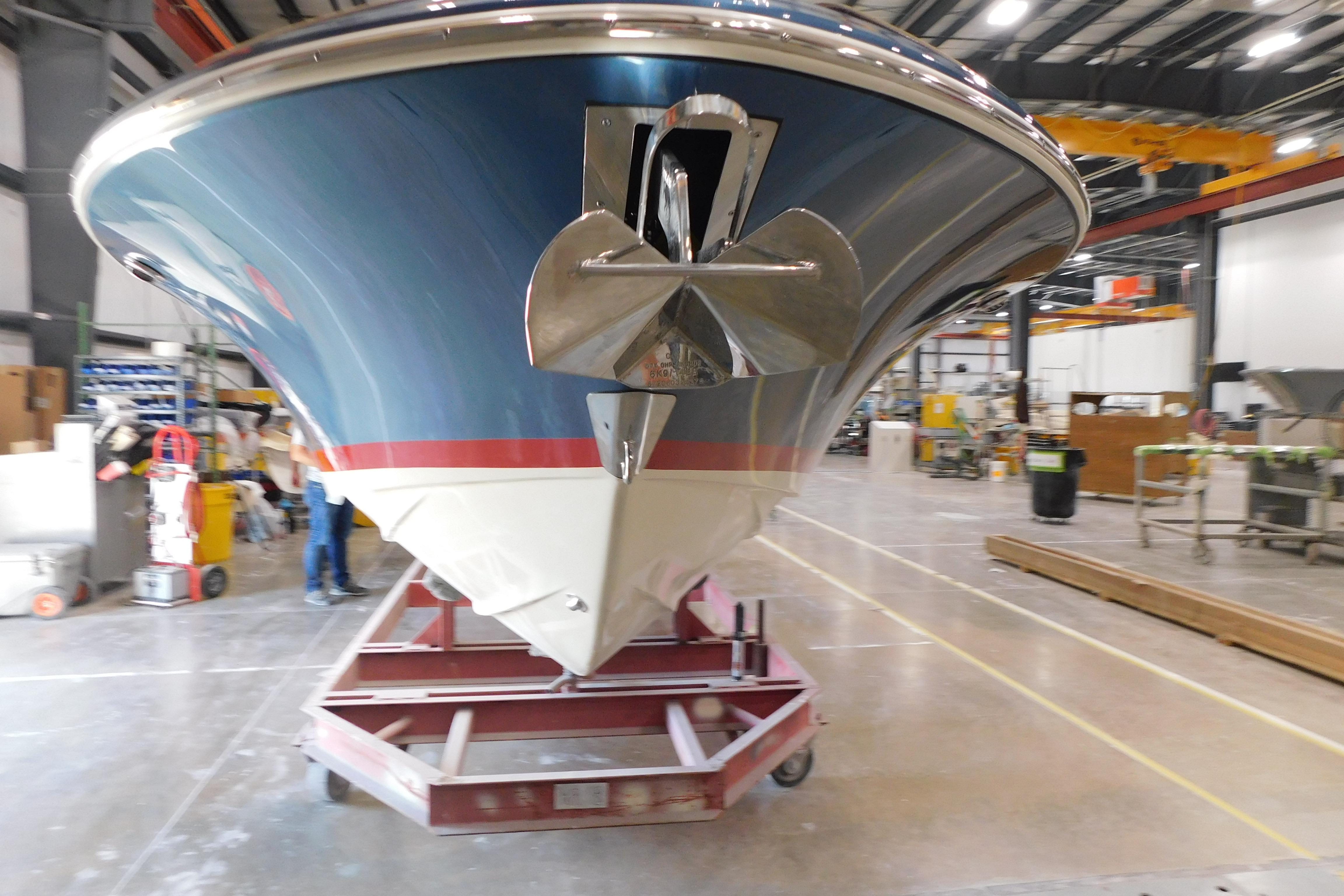 2025 Chris-Craft Launch 27 boat in a manufacturing facility, showcasing its sleek design.
