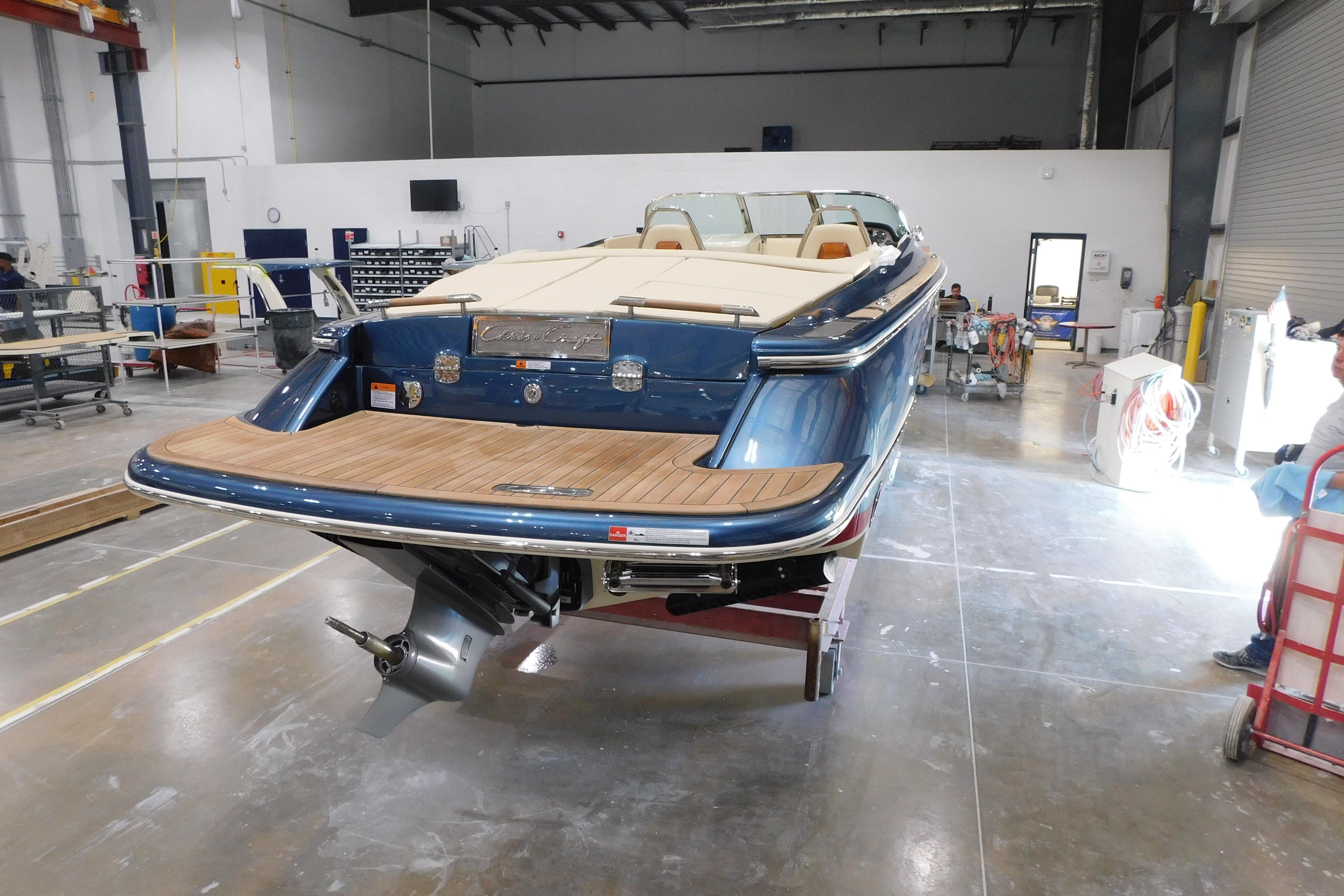 2025 Chris-Craft Launch 27 boat in a workshop, showcasing elegant design and craftsmanship.