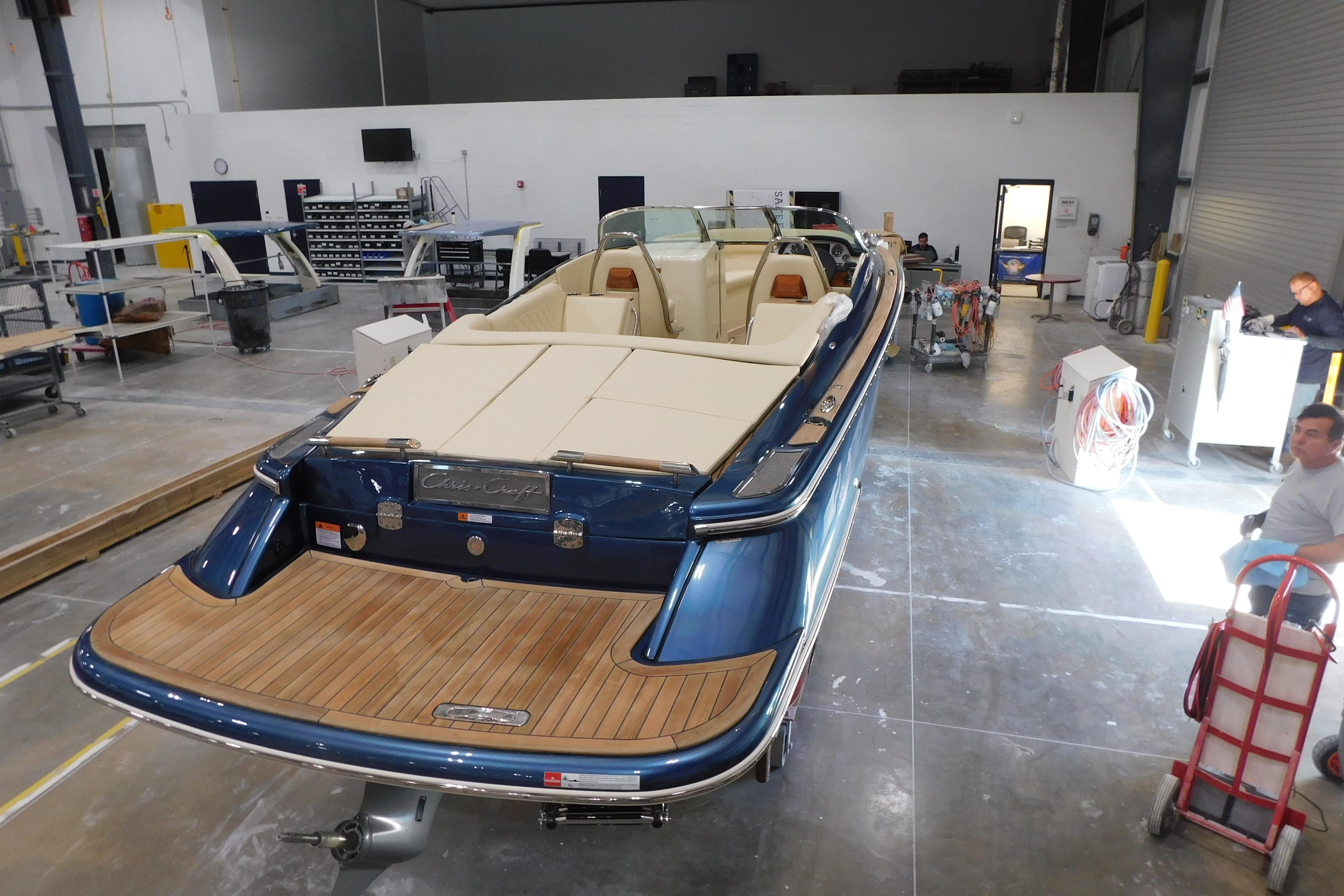 2025 Chris-Craft Launch 27 boat in a workshop, showcasing elegant design and craftsmanship.