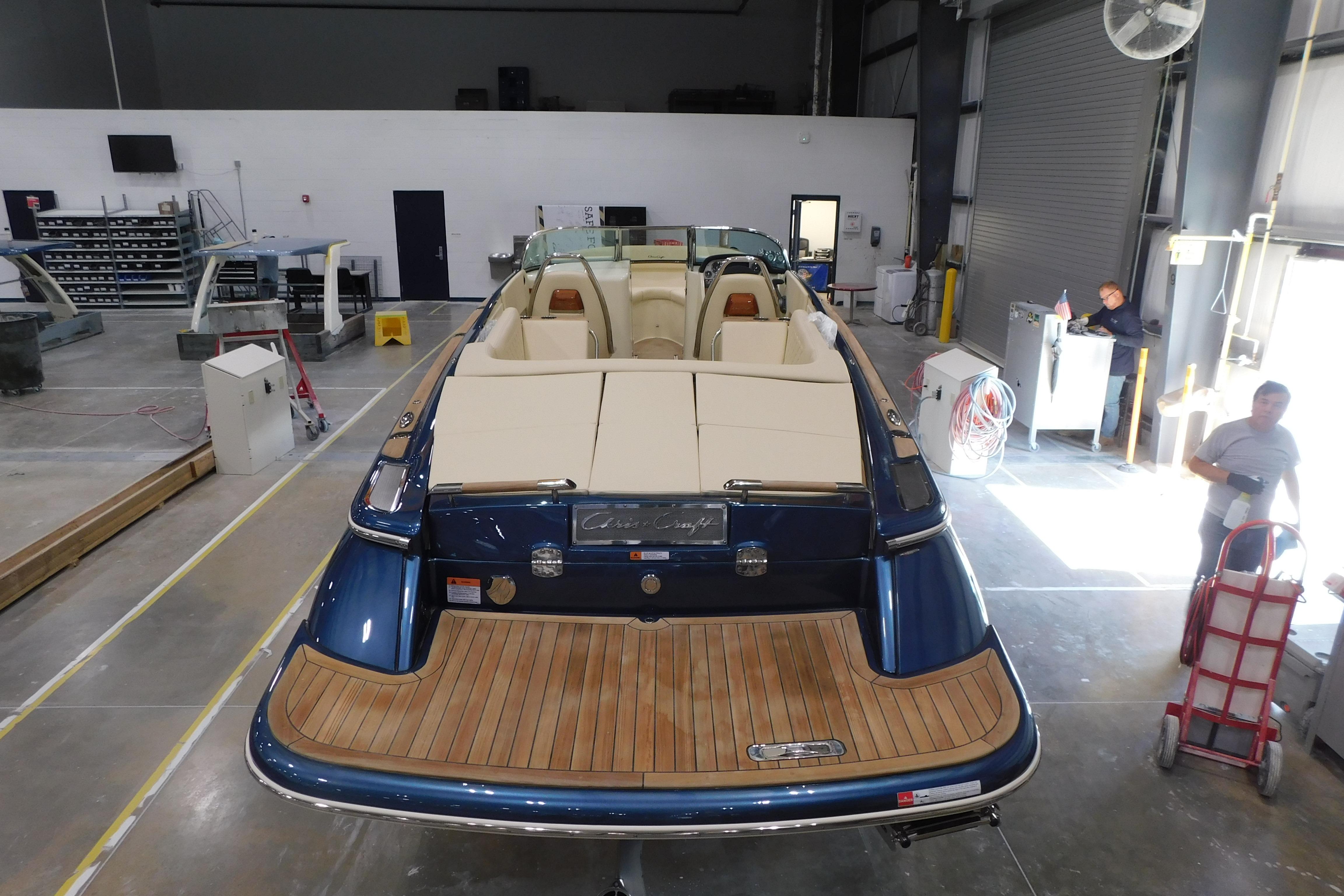 2025 Chris-Craft Launch 27 boat in a workshop, showcasing elegant design and craftsmanship.