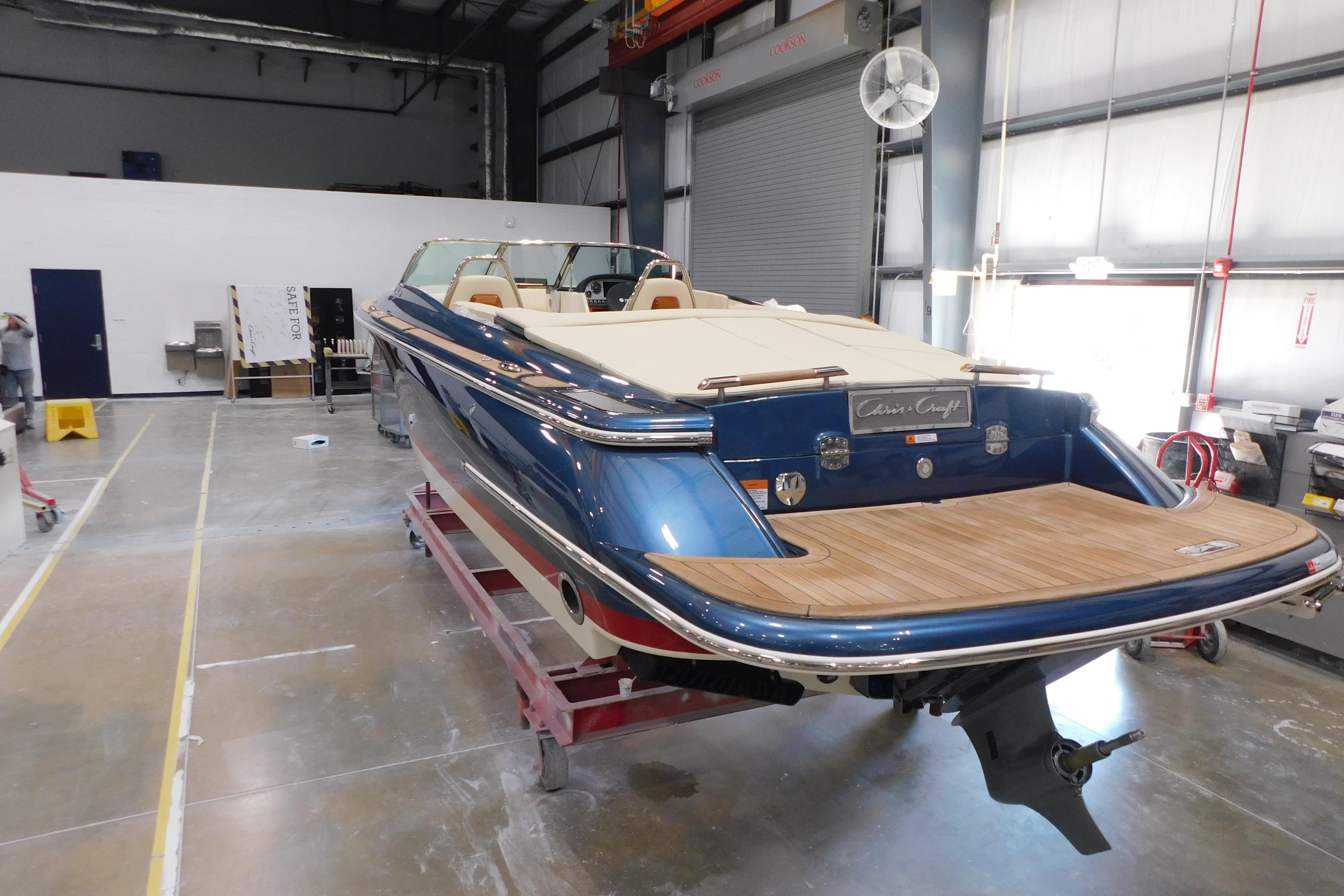 2025 Chris-Craft Launch 27 boat in a workshop, showcasing sleek design and craftsmanship.